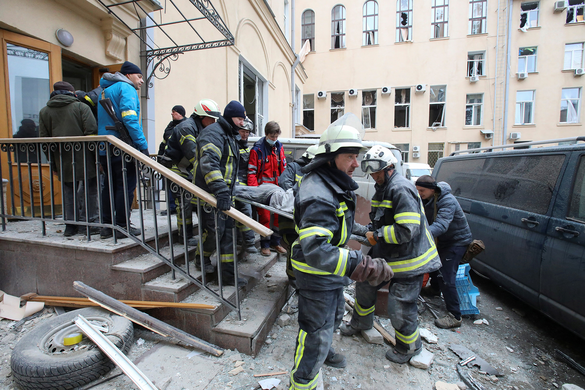 Rescuers carry the body of a victim on a stretcher outside the regional administration building, which city officials said was hit by a missile attack, in central Kharkiv, Ukraine, March 1, 2022. 