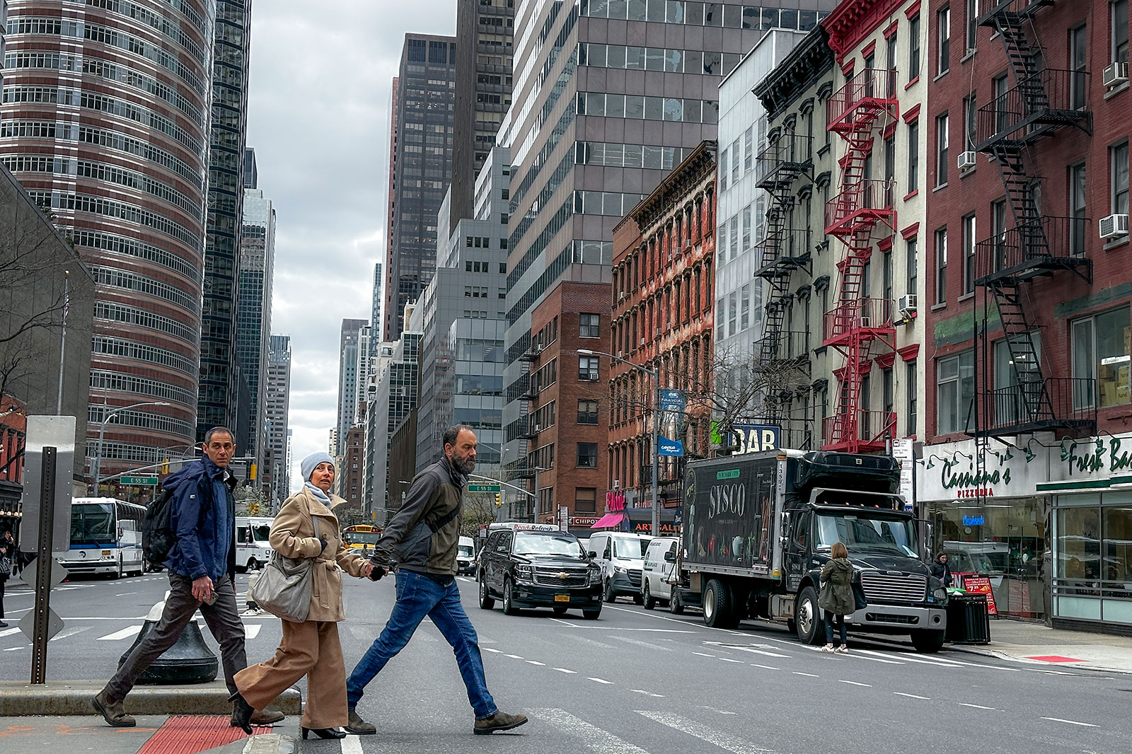 Pedestrians pass along 56th Street in New York after an earthquake on Friday.