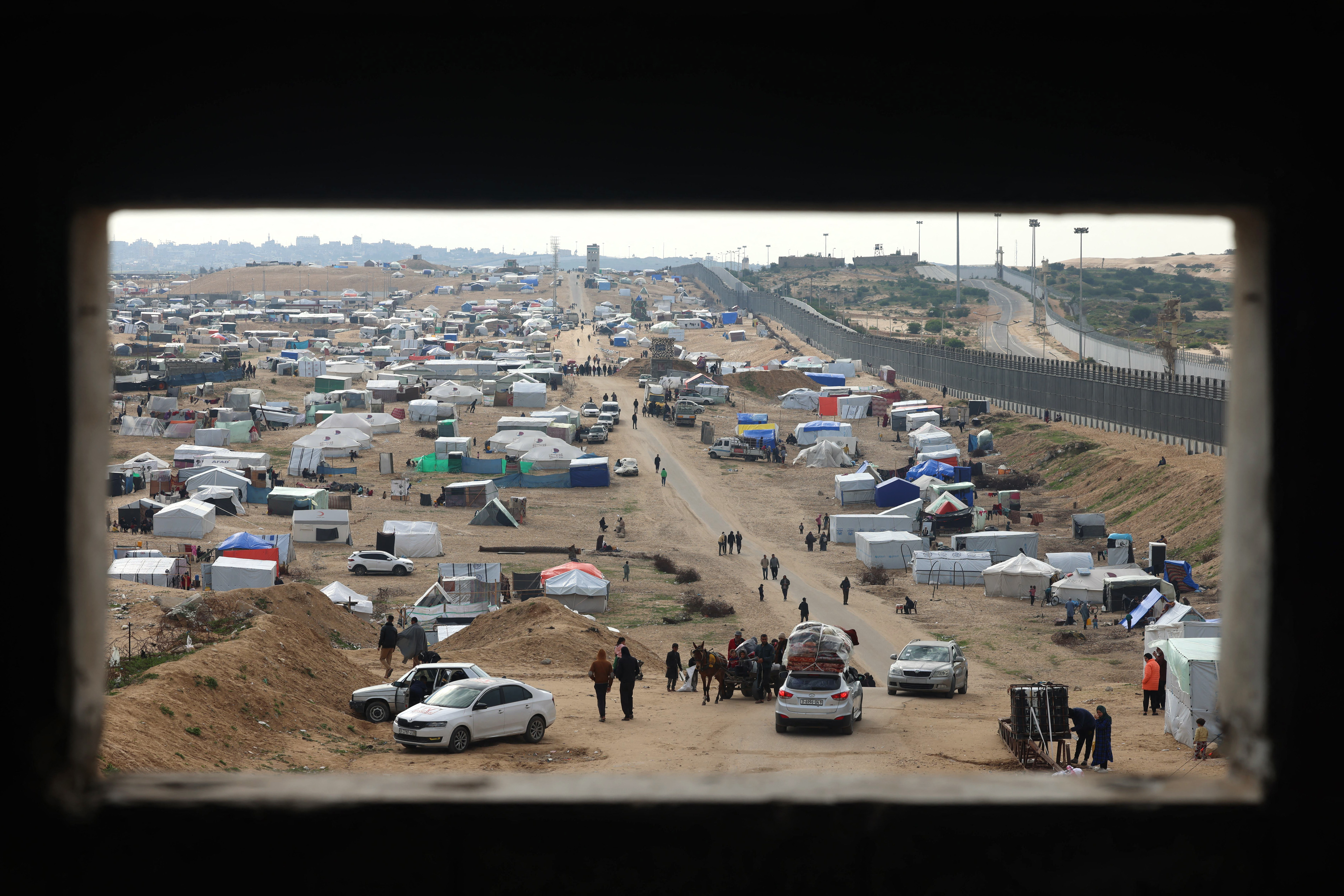 Displaced Palestinians camp in Rafah, Gaza, near the border fence with Egypt, on February 16.