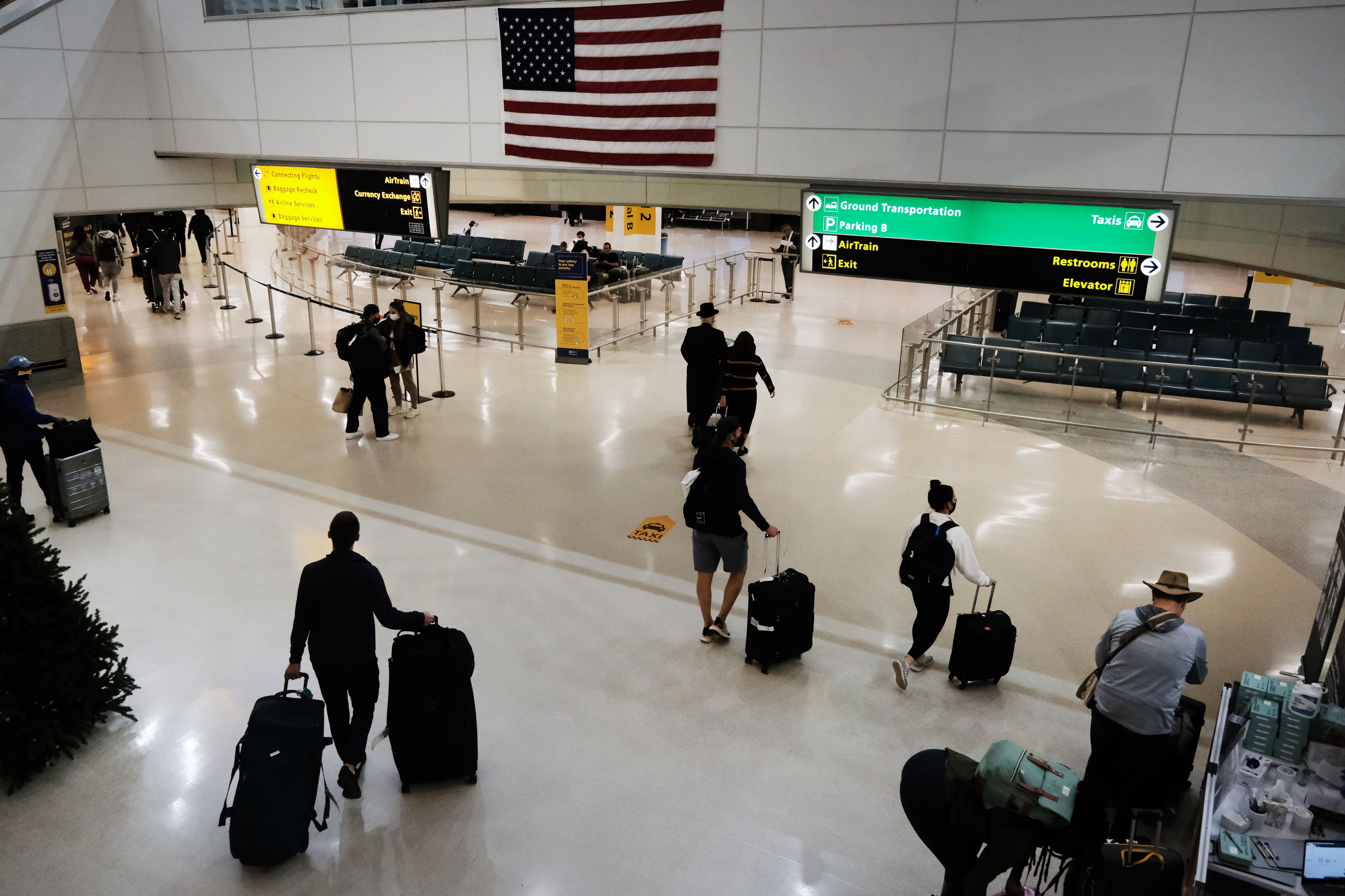 Travelers arrive from international flights at Newark Liberty International Airport in New Jersey on November 30.