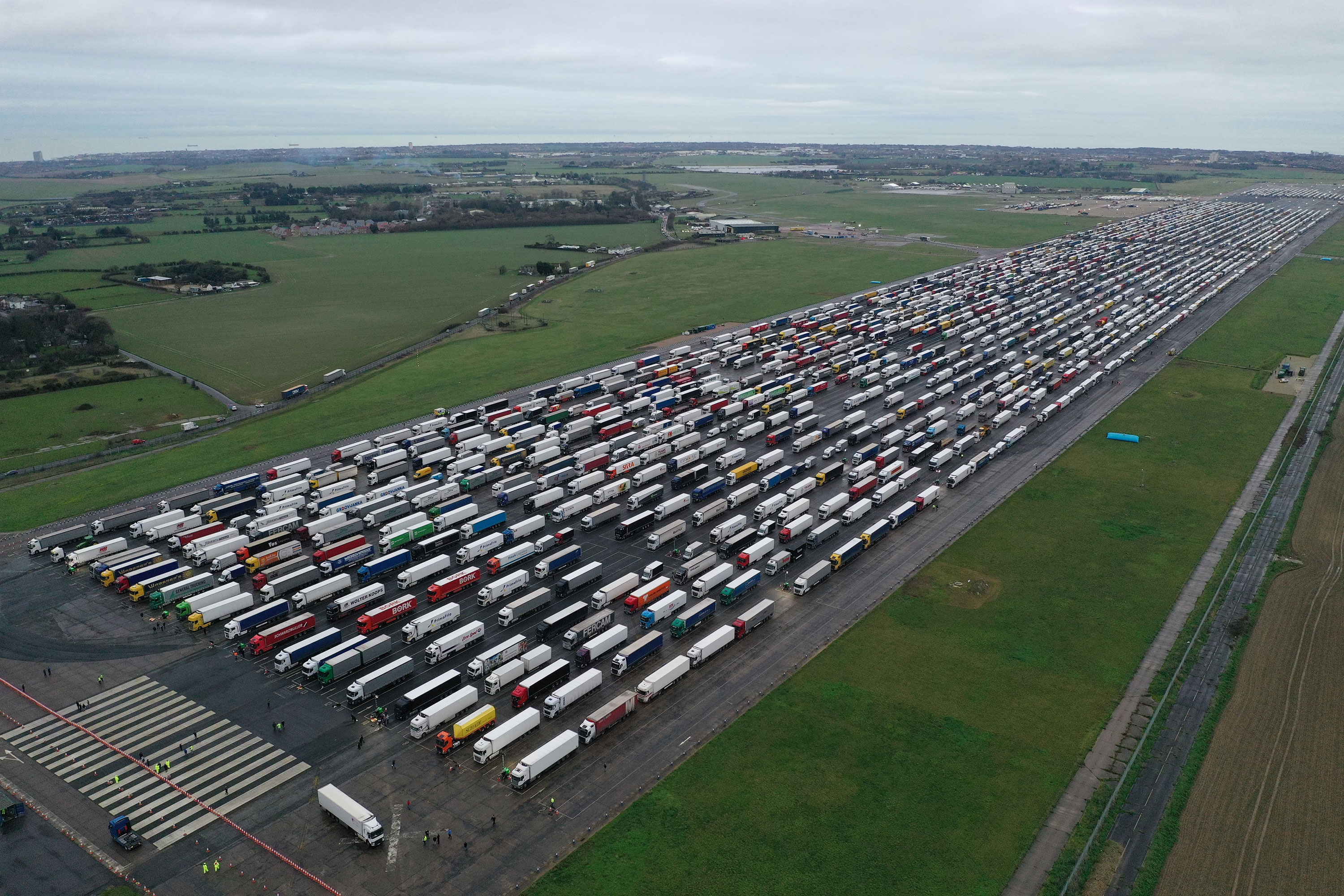 Lorries waiting to cross the English Channel are parked on the runway at Manston airport on December 22 in Kent, England. 