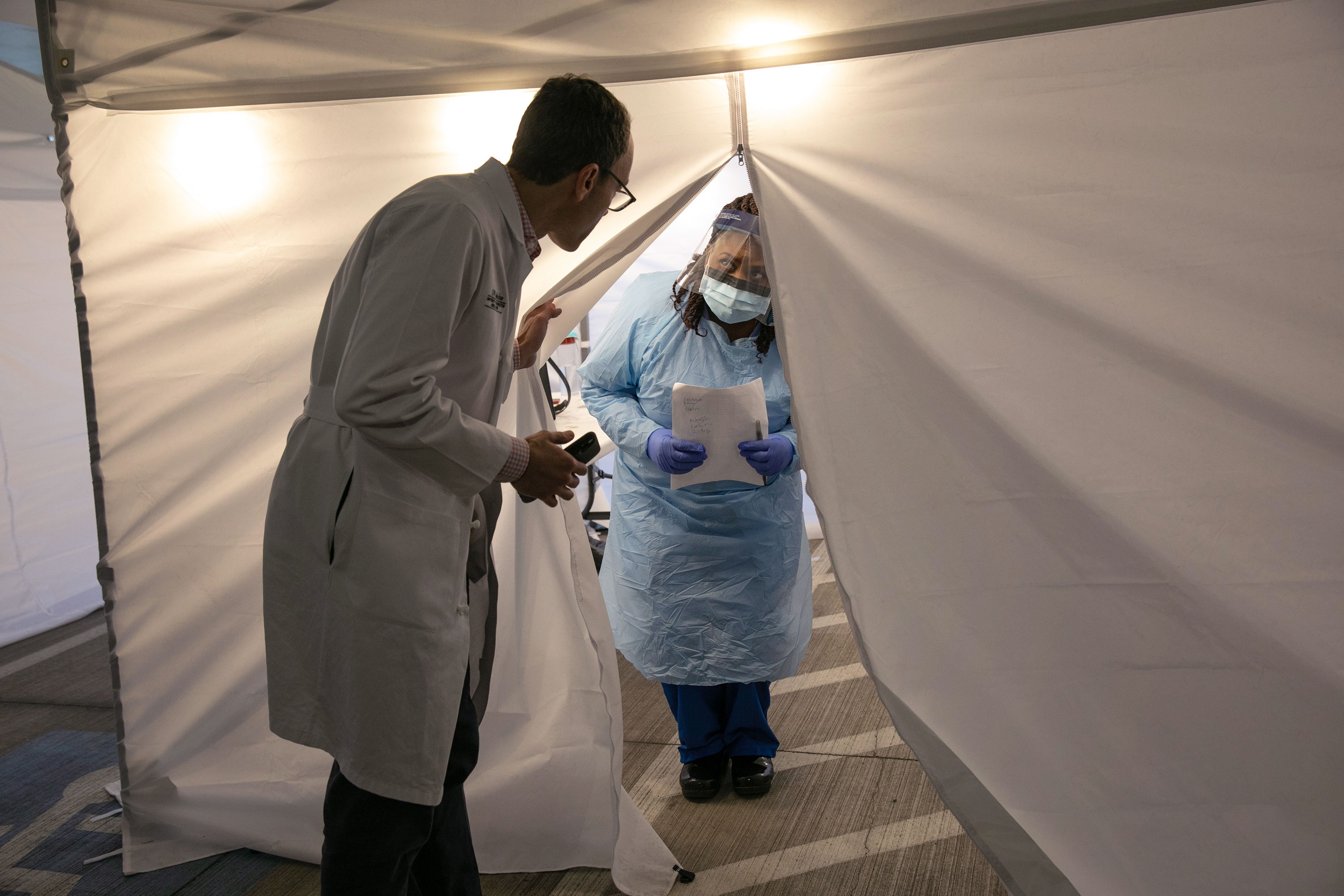 A doctor and a nurse converse before testing patients for coronavirus at the University of Washington Medical Center in Seattle on March 13.