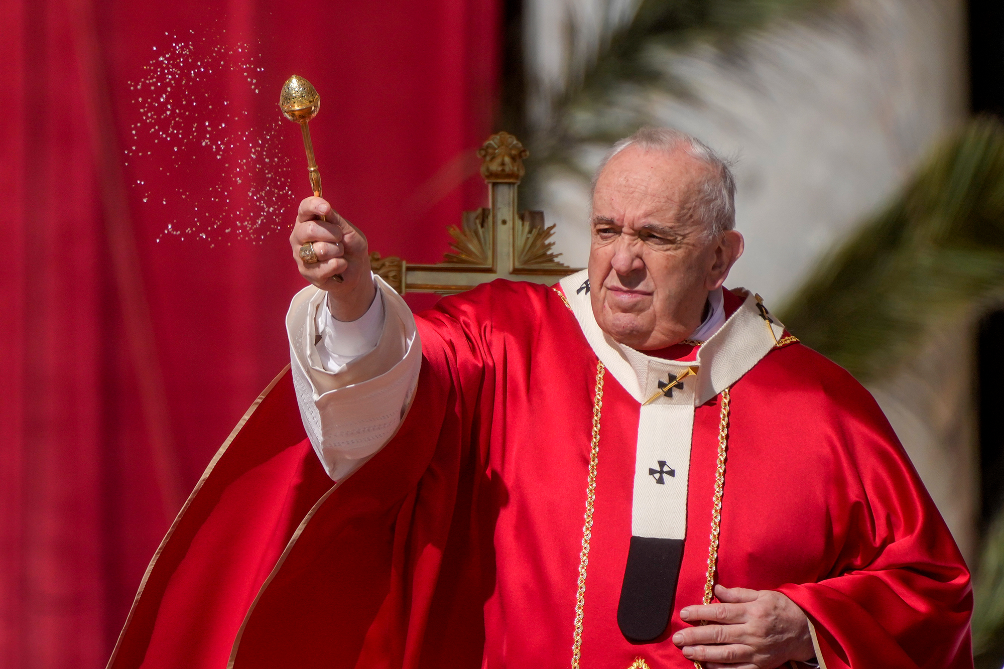 Pope Francis asperses holy water as he celebrates Palm Sunday Mass in St. Peter's Square at the Vatican on April 10. 