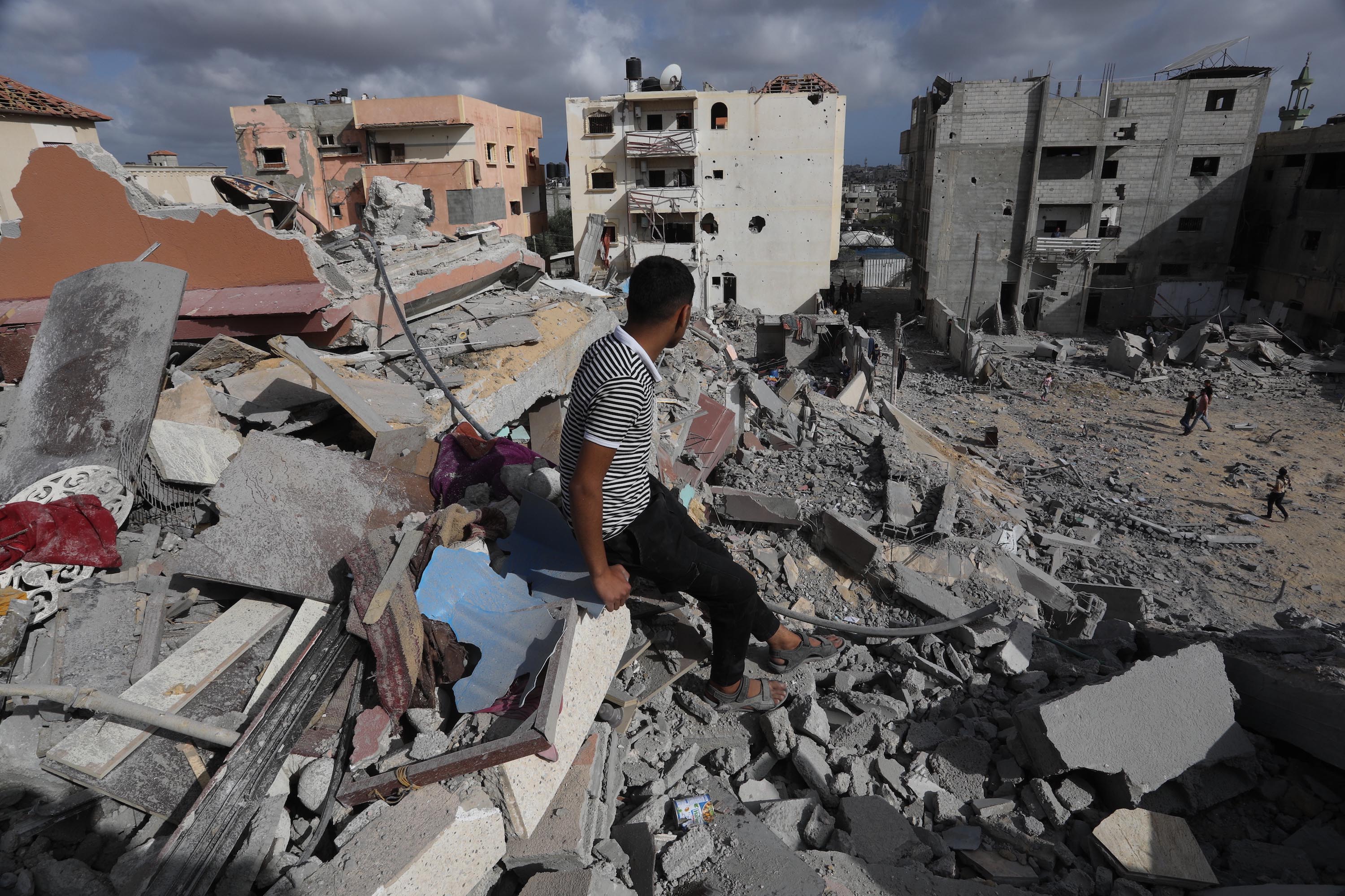 A man sits amid rubble of a destroyed building following Israeli attacks on the al-Salam neighborhood of Rafah on May 5. 