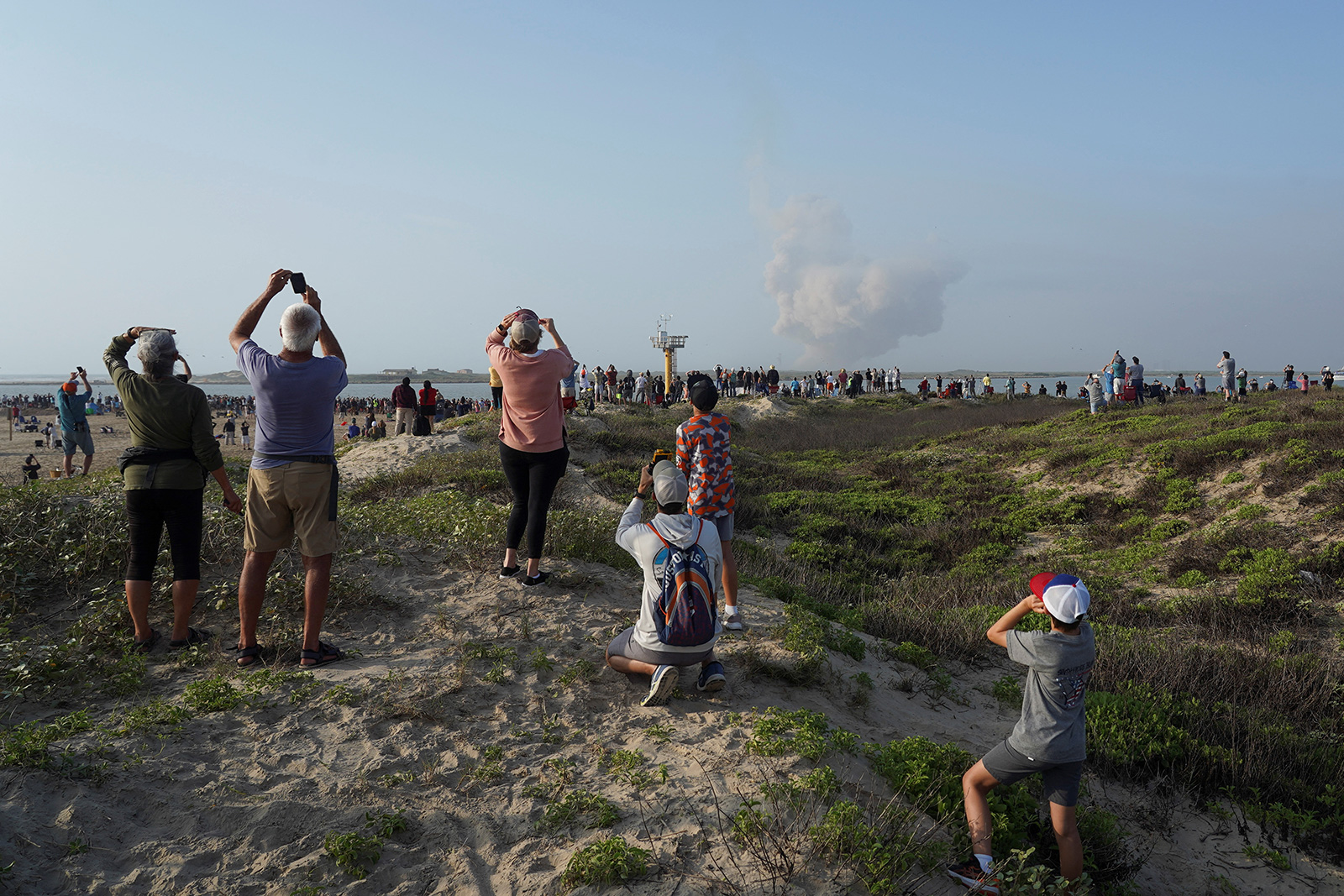 Onlookers watch as SpaceX's Starship take off near Brownsville, Texas, on Thursday, April 20.