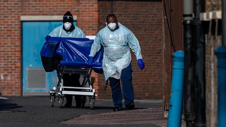Hospital workers wheel a concealment trolley, typically used for transporting bodies, to the mortuary at Lewisham Hospital on April 16, in London.