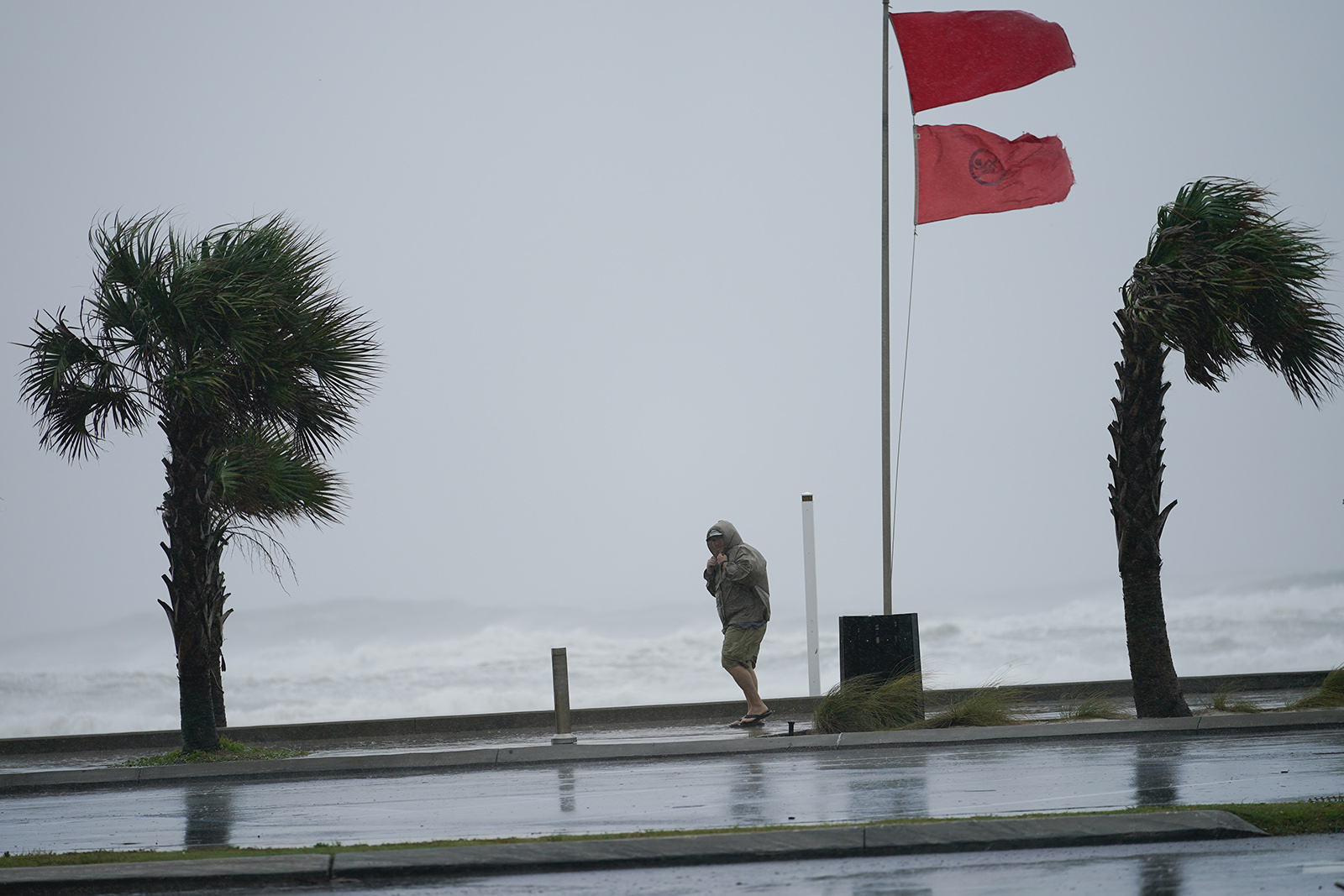 A man walks bear the gulf as Hurricane Sally moves in on Tuesday in Gulf Shores, Alabama.