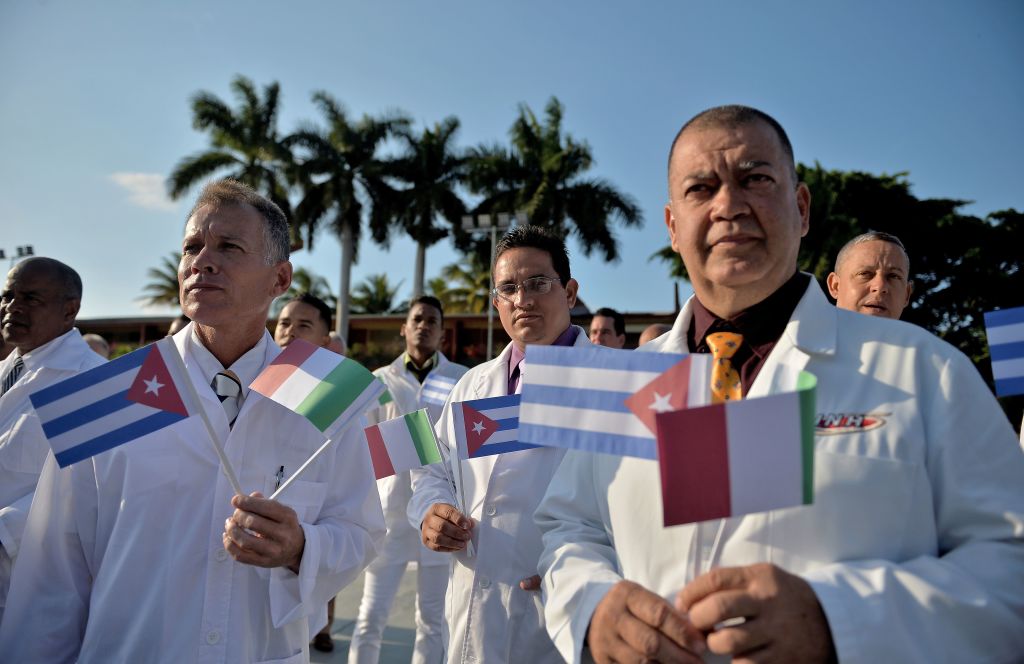 Doctors and nurses of Cuba's Henry Reeve International Medical Brigade are bid farewell before they travel to hard-hit Italy to help in the fight against the coronavirus pandemic, at the Central Unit of Medical Cooperation in Havana, on March 21.