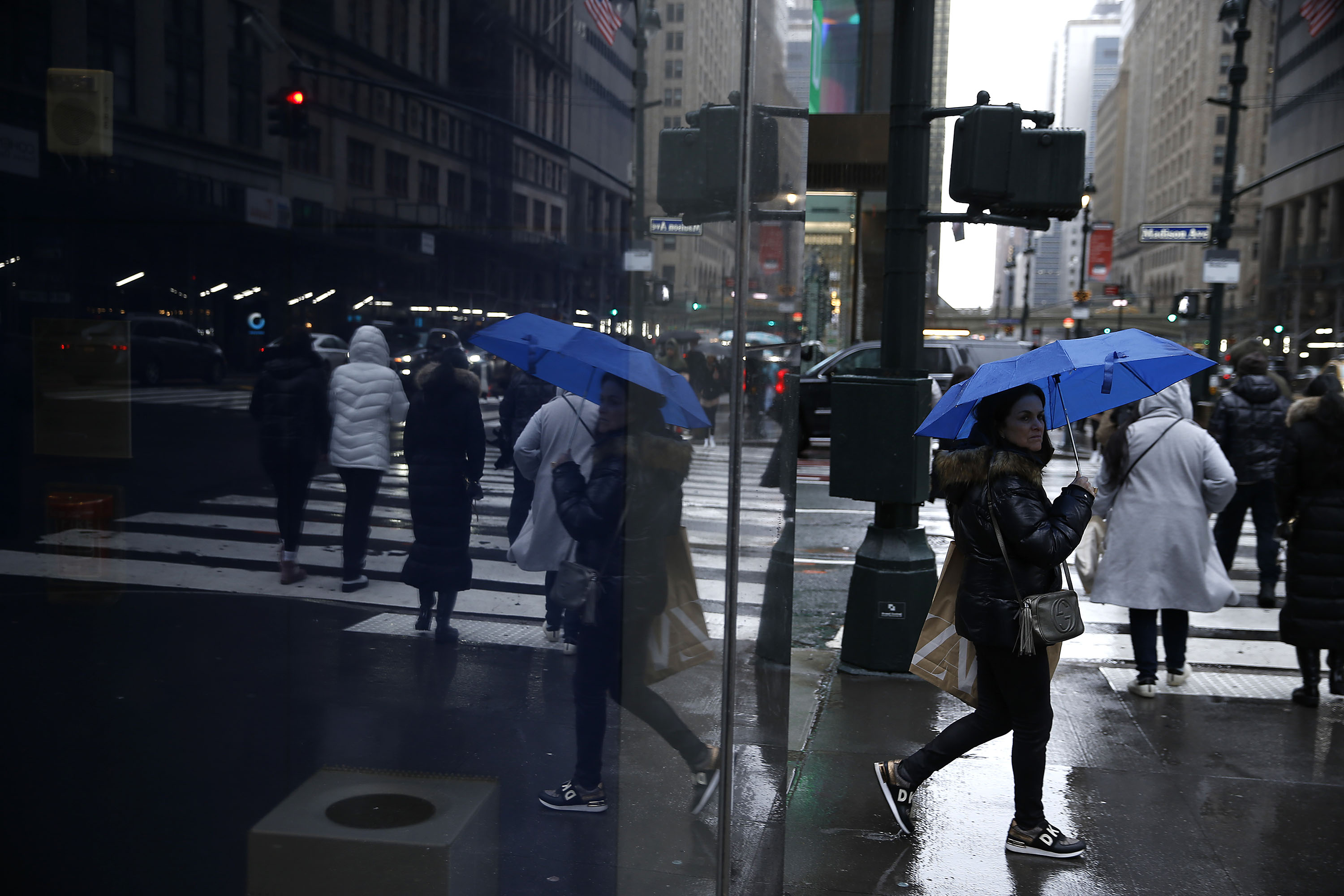 People walk along the street amid wintery weather in New York City, on January 7. 