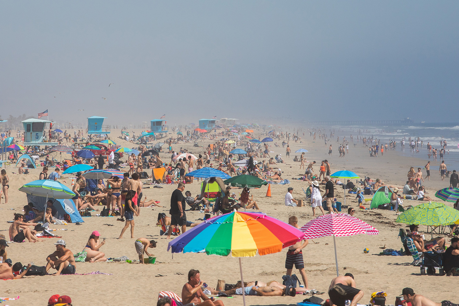 People enjoy the beach amid the novel coronavirus pandemic in Huntington Beach, California on April 25.