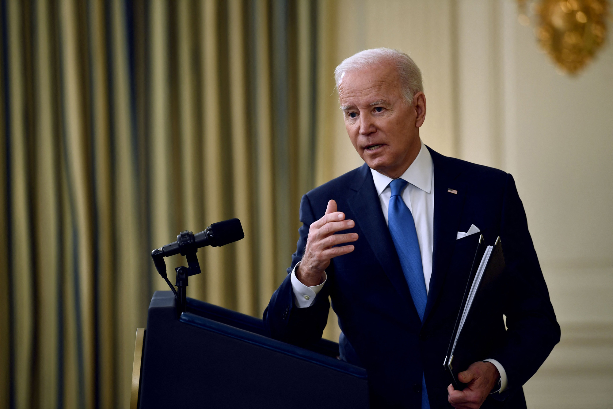 President Joe Biden answers speaks in the State Dining Room of the White House in Washington, DC, on December 21.