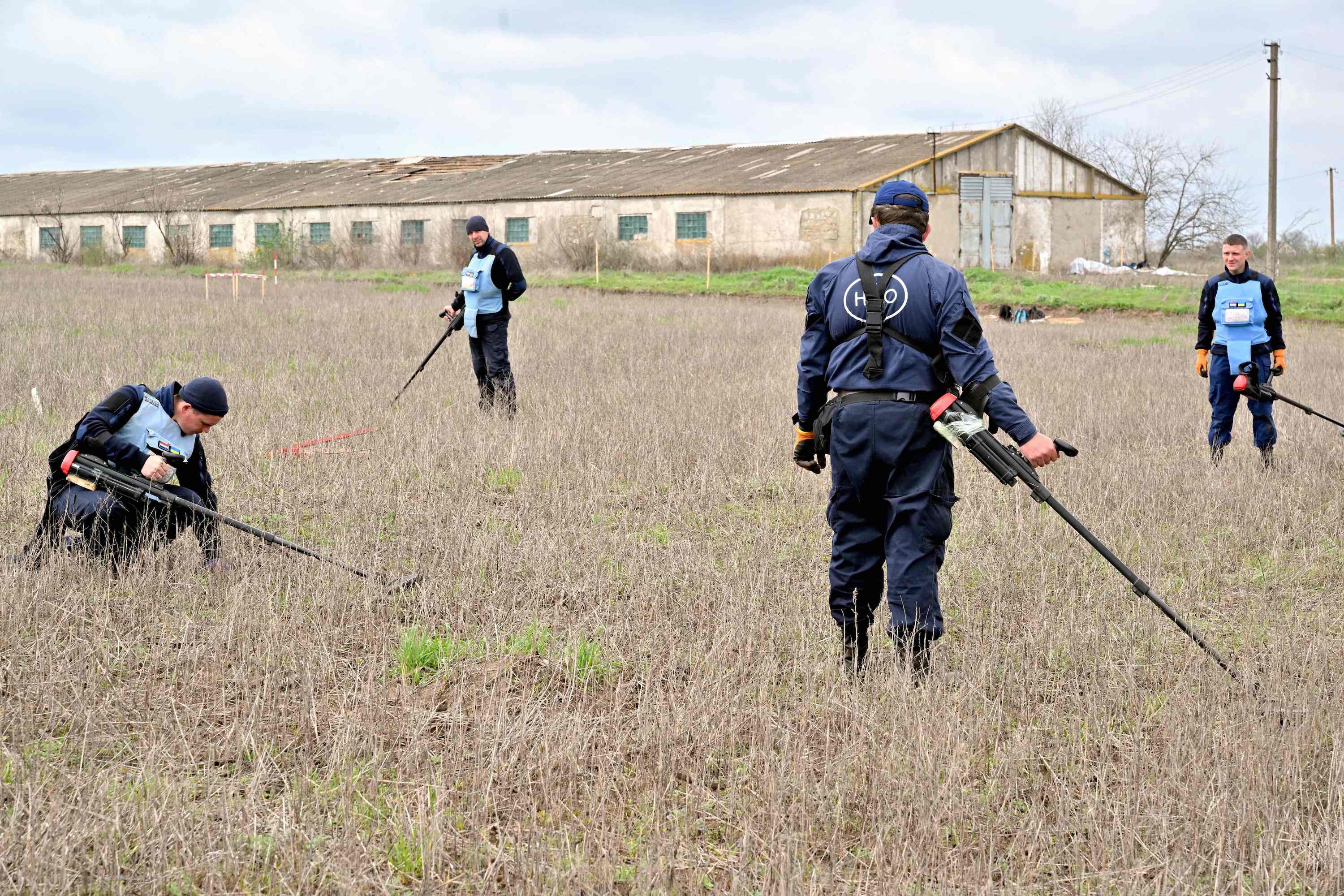 HALO Trust deminers are at work to clear a farm's land from explosives near the village of Yevgenivka, in the Mykolaiv region, on April 9, 2023, amid the Russian invasion of Ukraine.