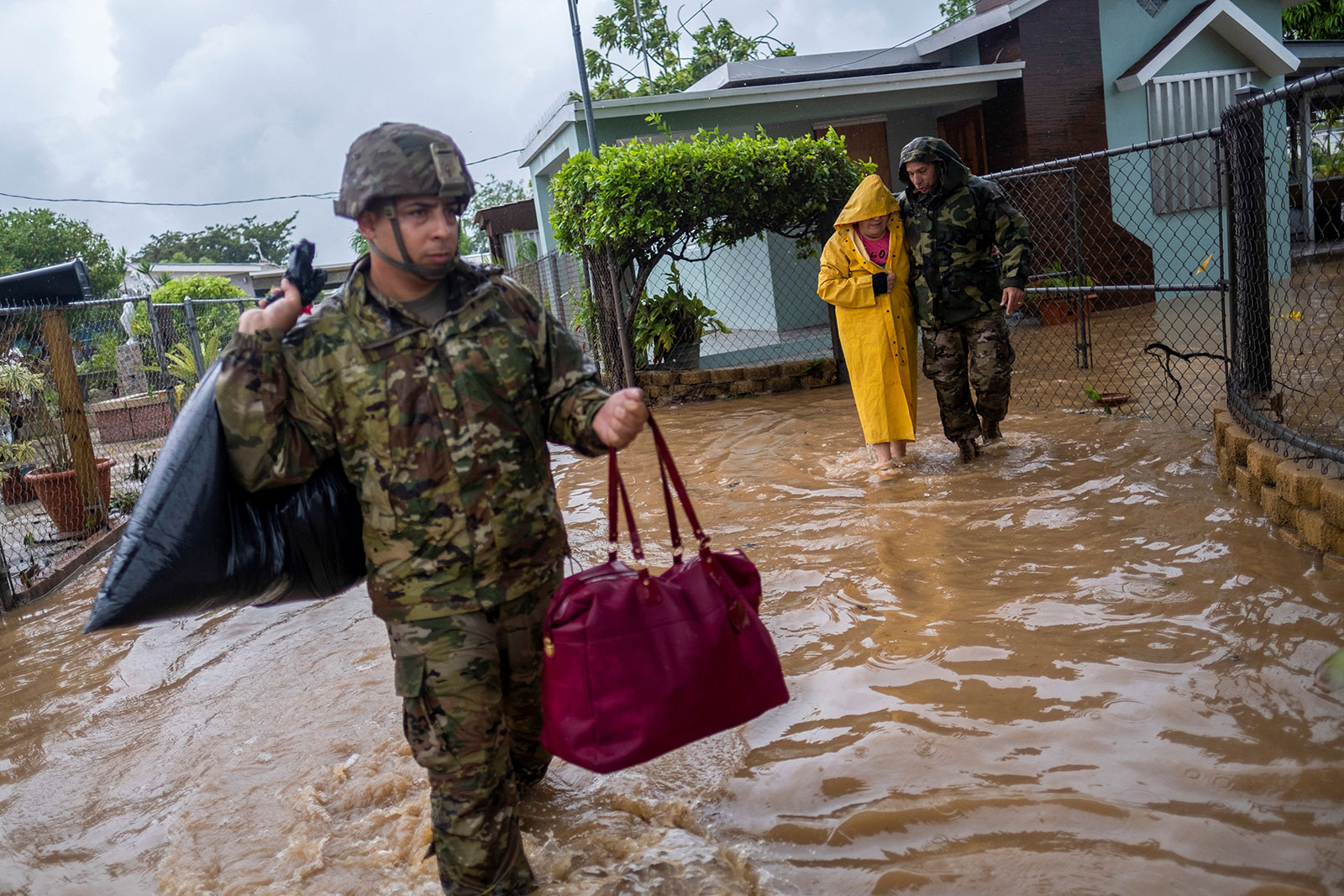 Members of the Puerto Rico National Guard rescue a woman stranded in her house in the aftermath of Hurricane Fiona in Salinas, Puerto Rico on Monday, September 19. 