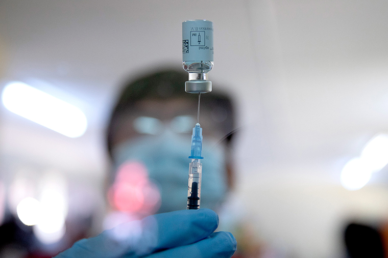 A health care worker fills a syringe from a vial with a dose of the Johnson & Johnson vaccine against the COVID-19 coronavirus as South Africa proceeds with its inoculation campaign at the Klerksdorp Hospital on February 18.