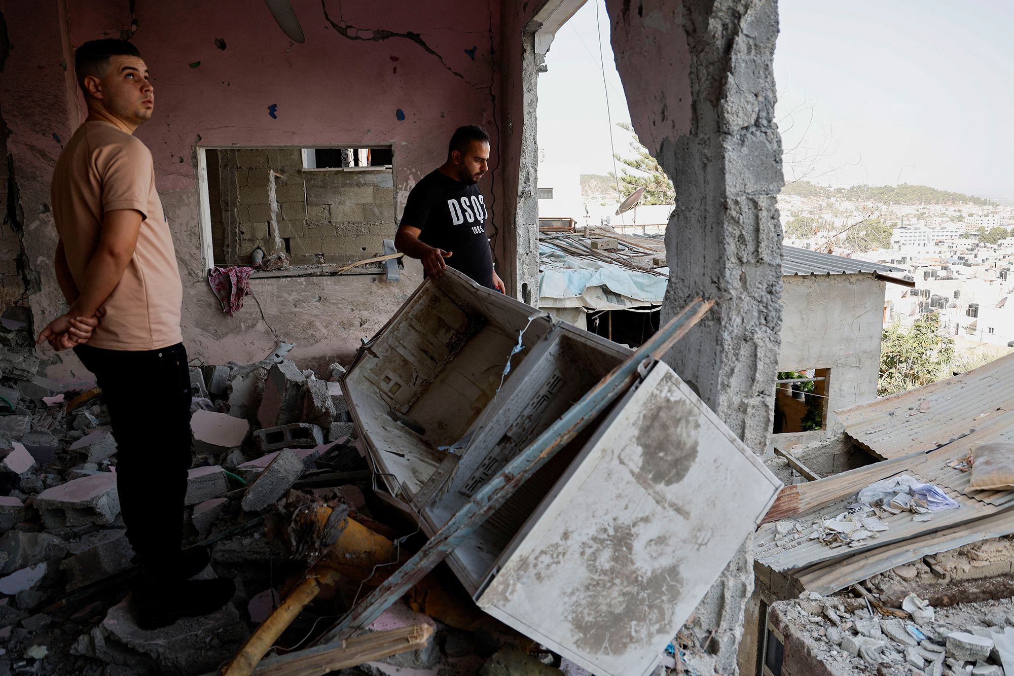 People check the damage at a mosque following an Israeli airstrike in Jenin, West Bank, on October 22. 