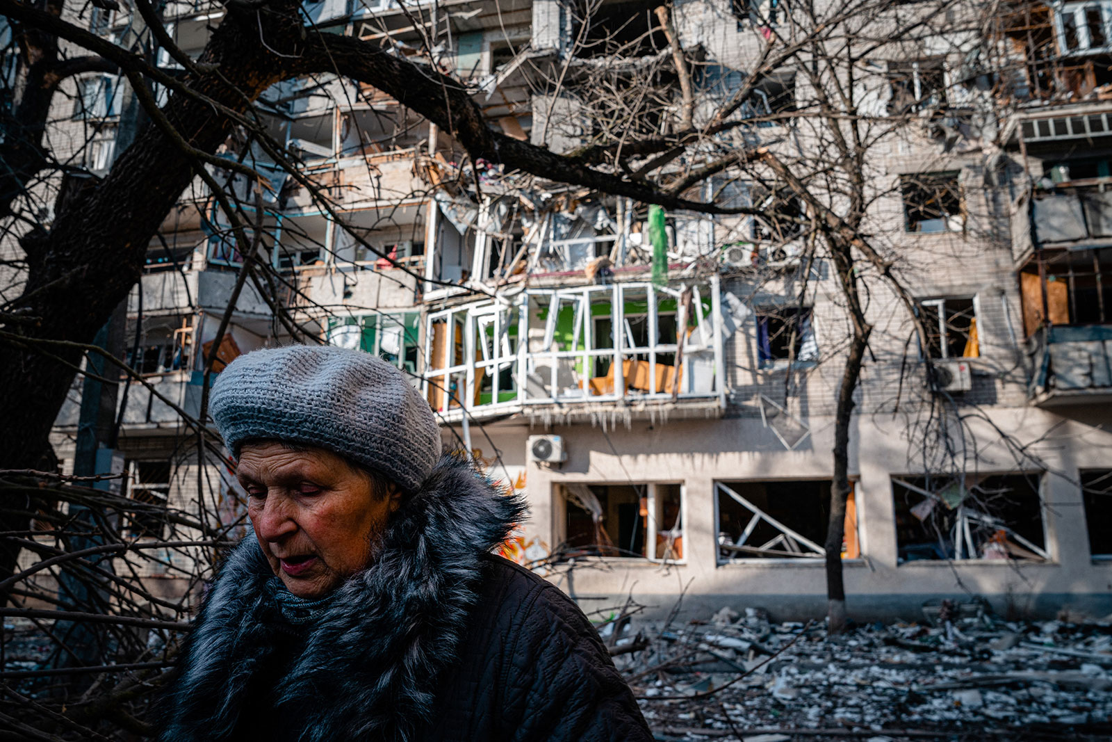 A pedestrian walks past a residential building damaged by Russian shelling in Kherson, Ukraine, on December 20. 