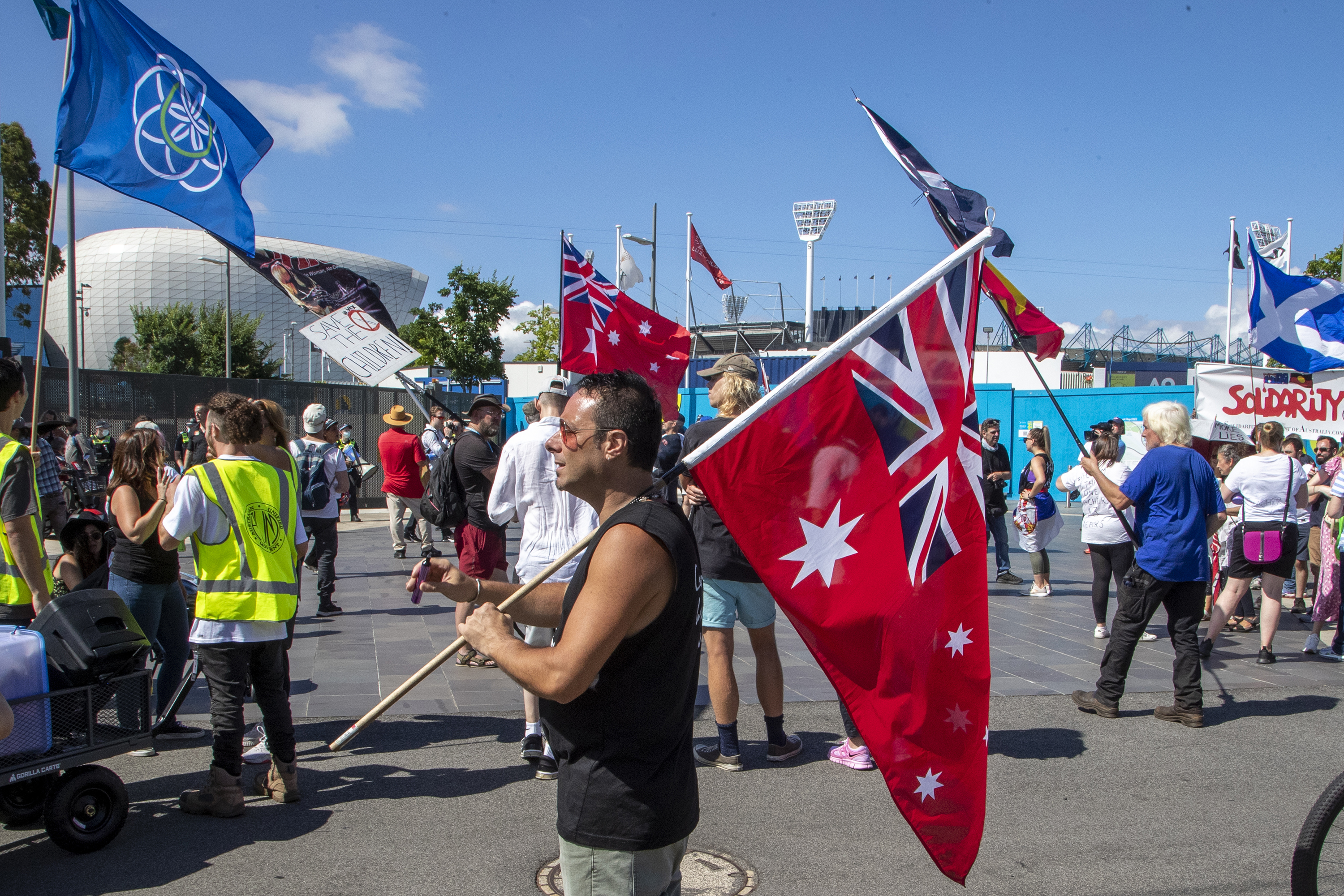 Protesters demonstrate outside Melbourne Park after Novak Djokovic returned to an immigration prison hotel in Melbourne on Saturday.