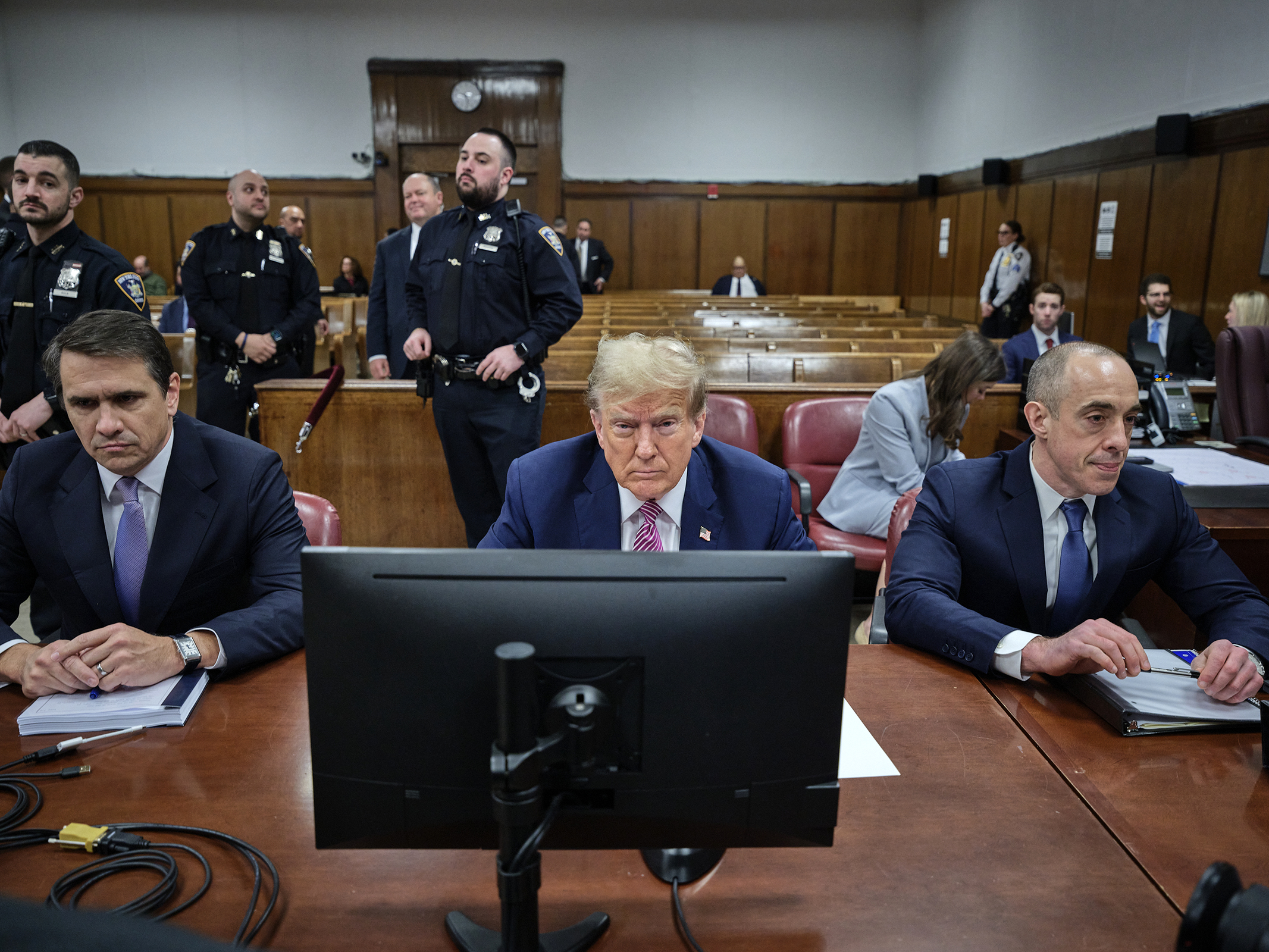 Former President Donald Trump, flanked by attorneys Todd Blanche, left, and and Emil Bove, right, arrives for his criminal trial as jury selection continues at Manhattan Criminal Court on April 19, in New York City. 