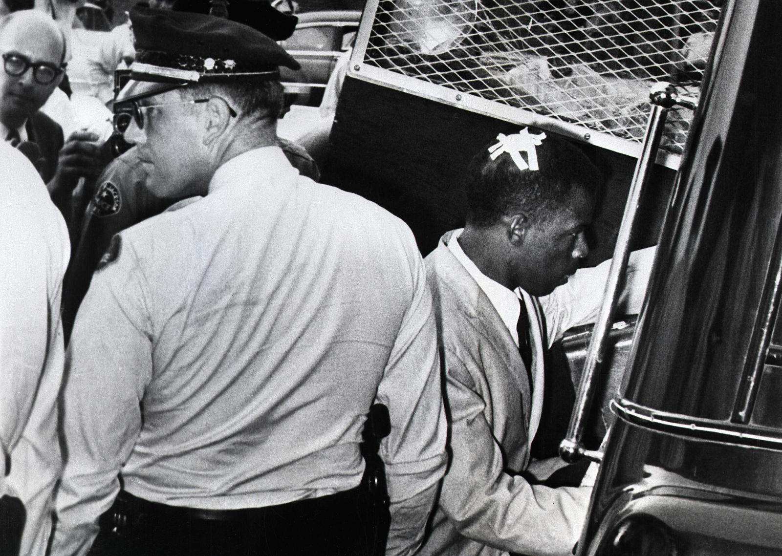 Lewis has tape on his head, marking the spot where he was struck during racial violence in Montgomery, Alabama, in May 1961. That month, the Freedom Ride movement began with interstate buses driving into the Deep South to challenge segregation that persisted despite recent Supreme Court rulings. In some cities, the activists were arrested and brutally beaten.