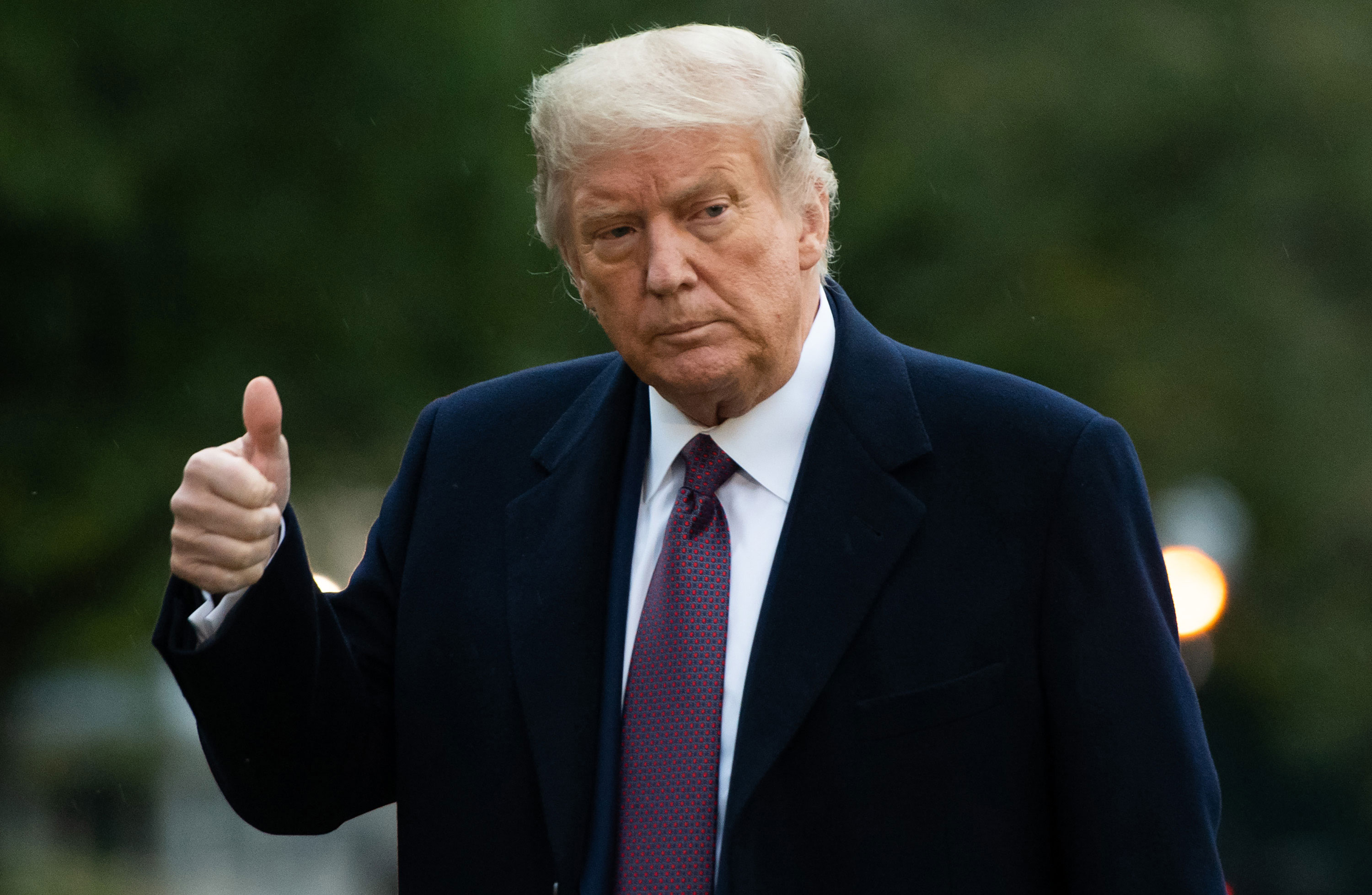 President Donald Trump gives a thumbs up as he walks from Marine One after arriving on the South Lawn of the White House on October 1.