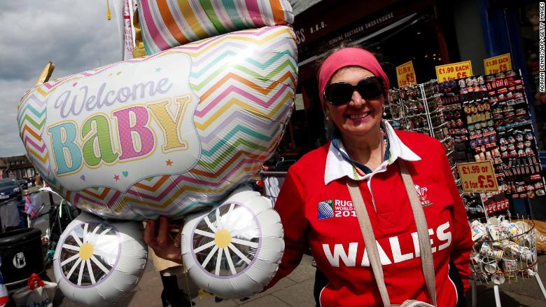 Royal super fan Anne Daley poses with baby-themed balloons as she waits near Windsor Castle, west of London on Monday.