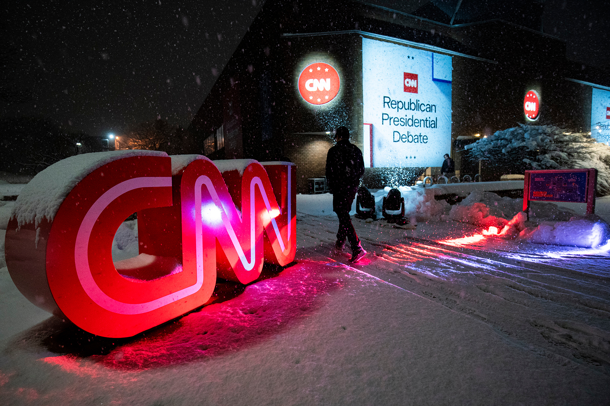 A member of the media walks from the debate hall during the Republican primary presidential debate hosted by CNN in Des Moines, Iowa, US, on January 10.
