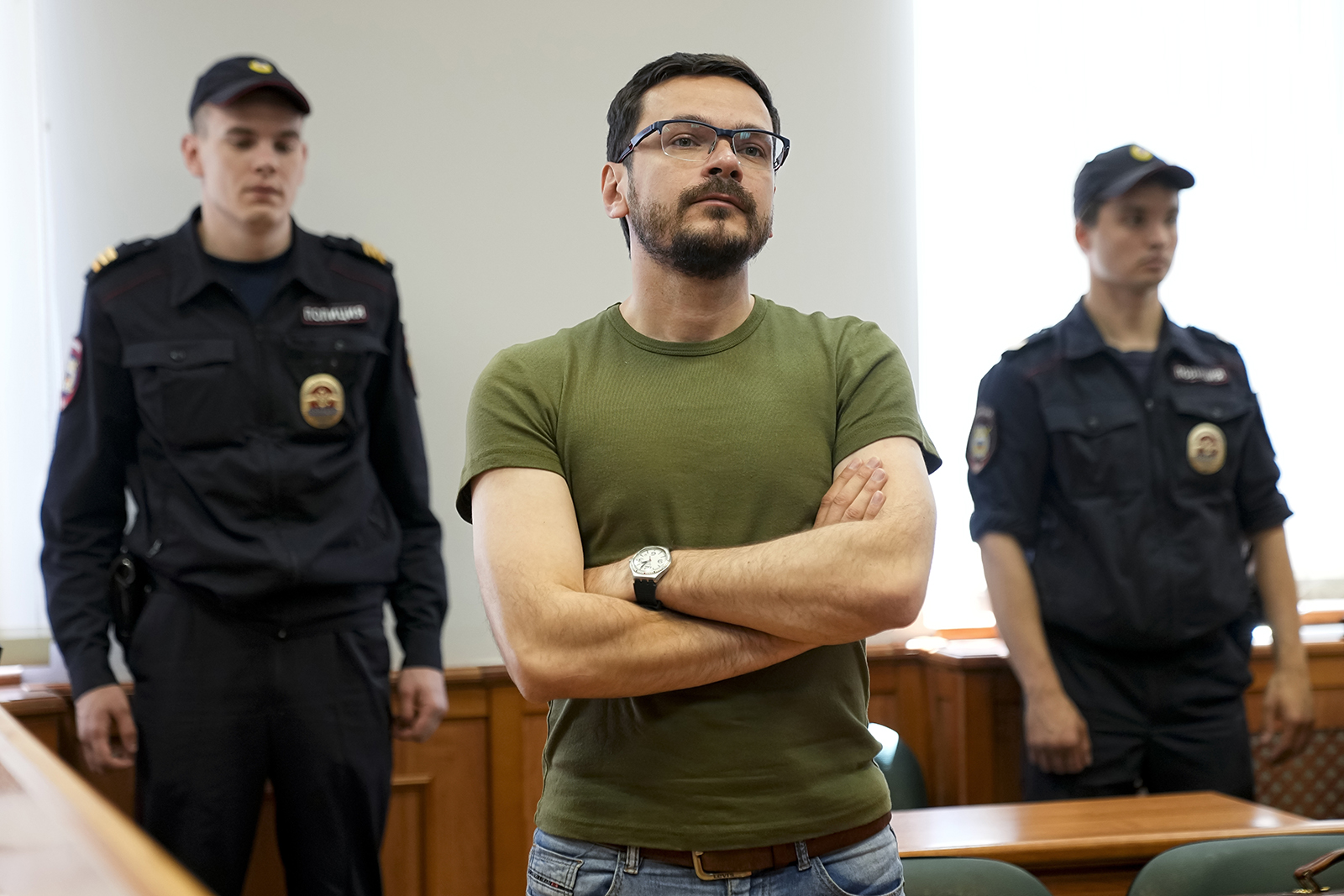 Ilya Yashin, center, listens to the court's decision in Moscow on June 29. A court in Moscow has rejected the appeal of a prominent opposition figure of the 15-day jail term he was handed on charges of failure to obey police. 