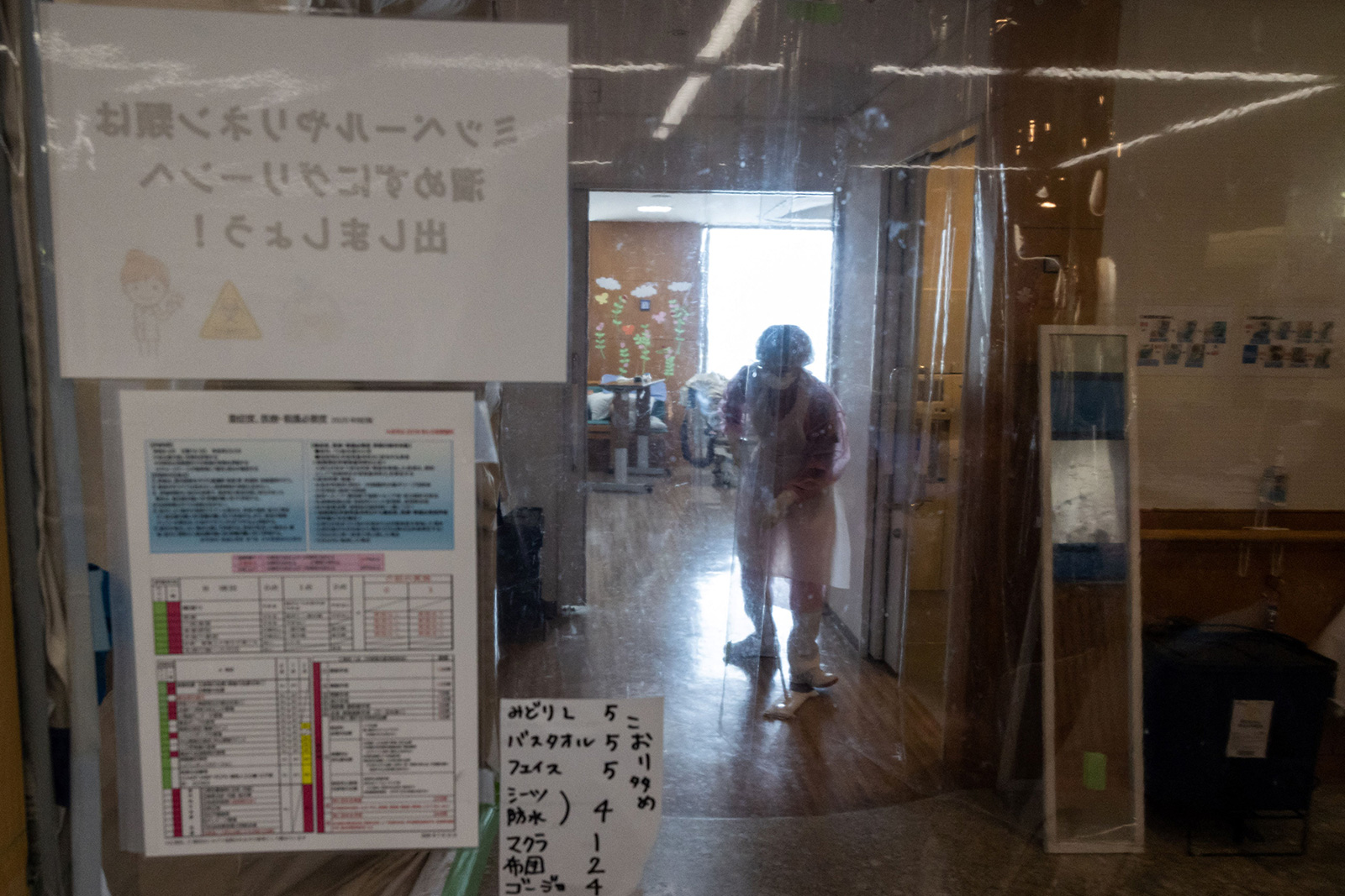 A Pegasus Corporation cleaner disinfects the floor of the "red zone" of the Covid-19 ward at St. Marianna University Kawasaki Municipal Tama Hospital outside of Tokyo on June 15.