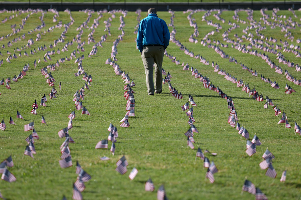 A man walks through a COVID Memorial Project installation on the grounds of the Washington Monument in Washington, DC on September 22.