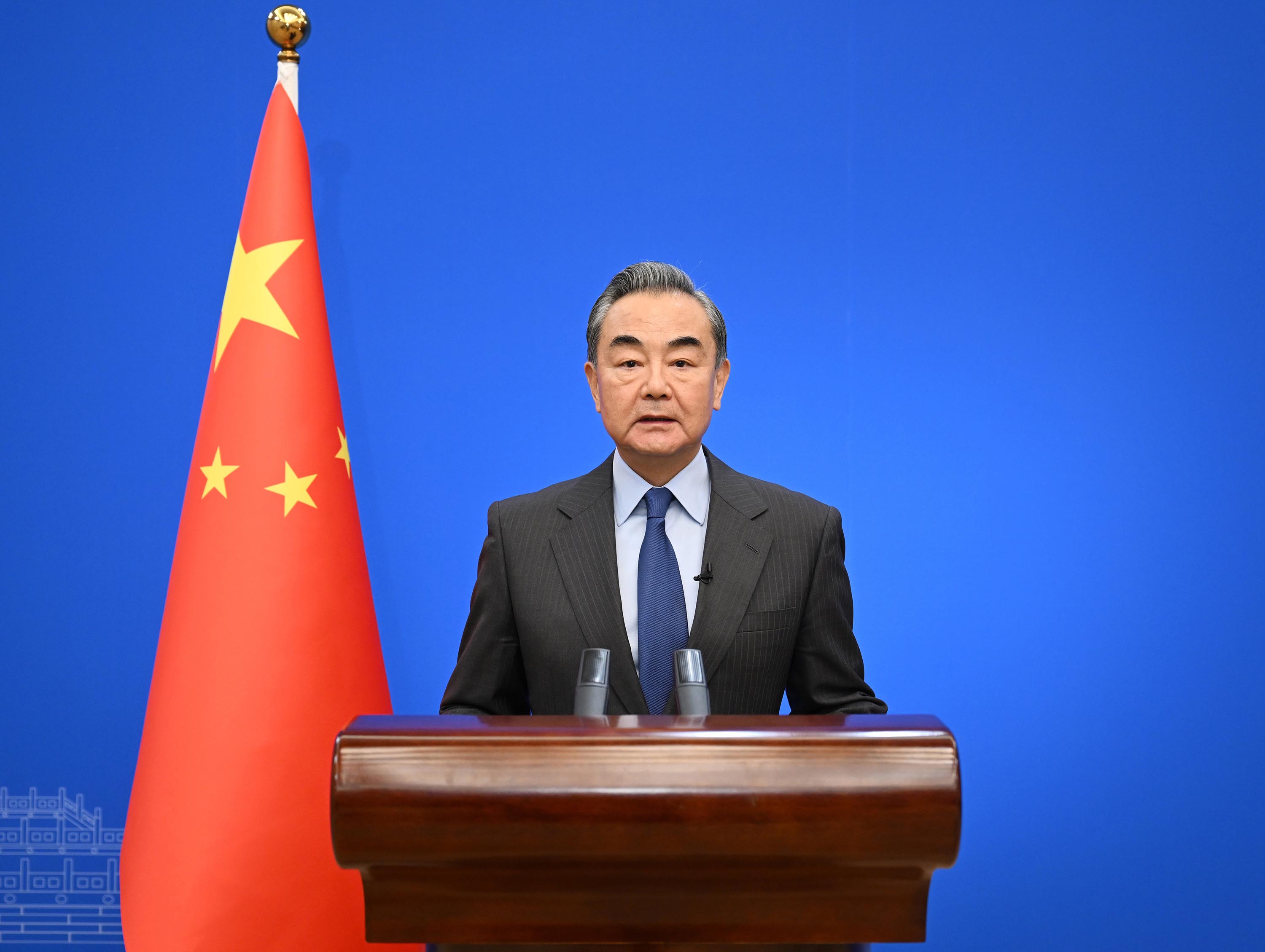 Wang Yi speaks during a symposium on December 25, 2022. 