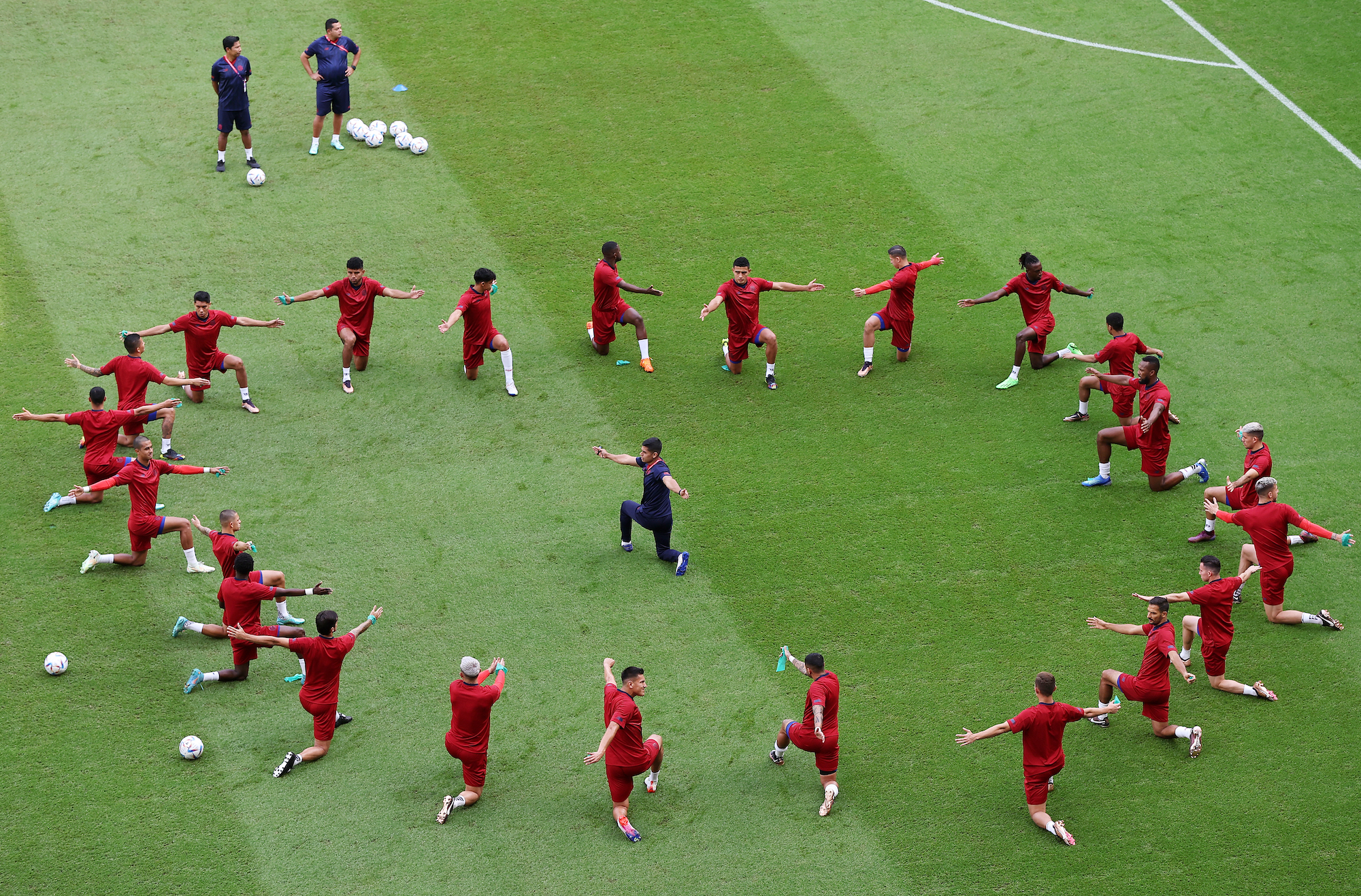 Costa Rican players warm up prior to a match against Japan at Ahmad Bin Ali Stadium on Sunday.