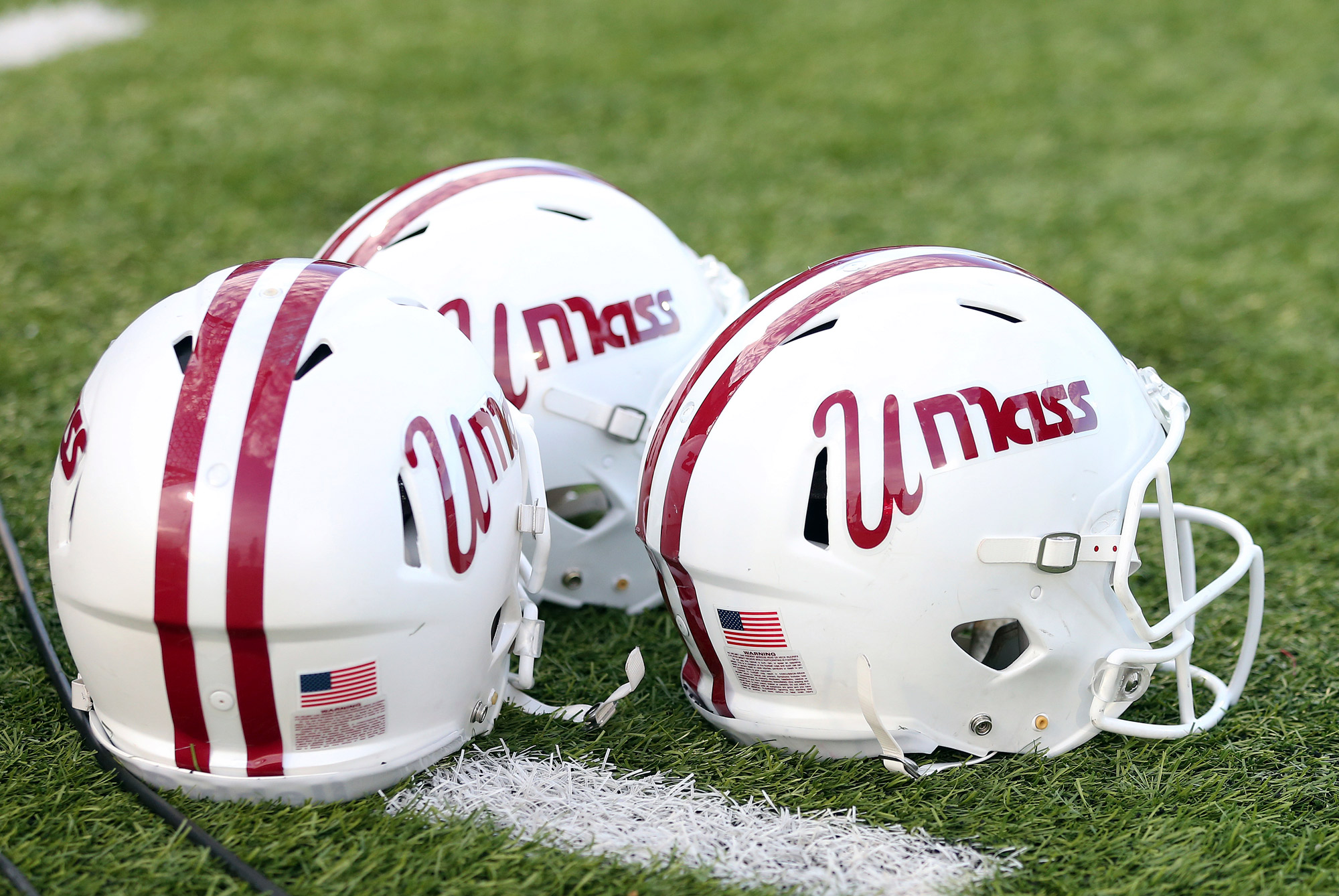UMass Minutemen helmets sit on the ground on October 26, 2019, at Warren McGuirk Alumni Stadium in Amherst, Massachusetts.  