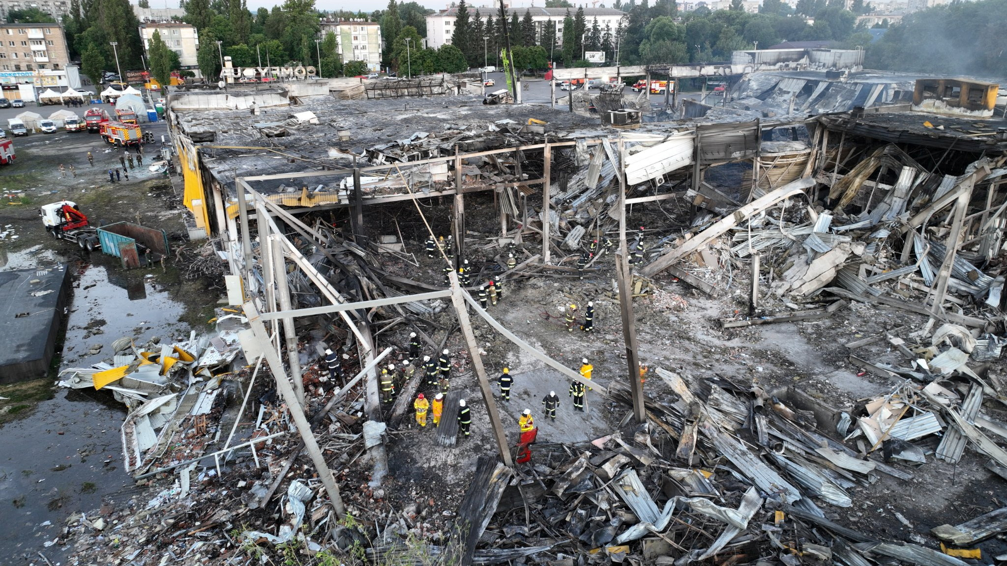 Rescuers work at a site of a shopping mall hit by a Russian missile strike in Kremenchuk, Ukraine, on June 28.