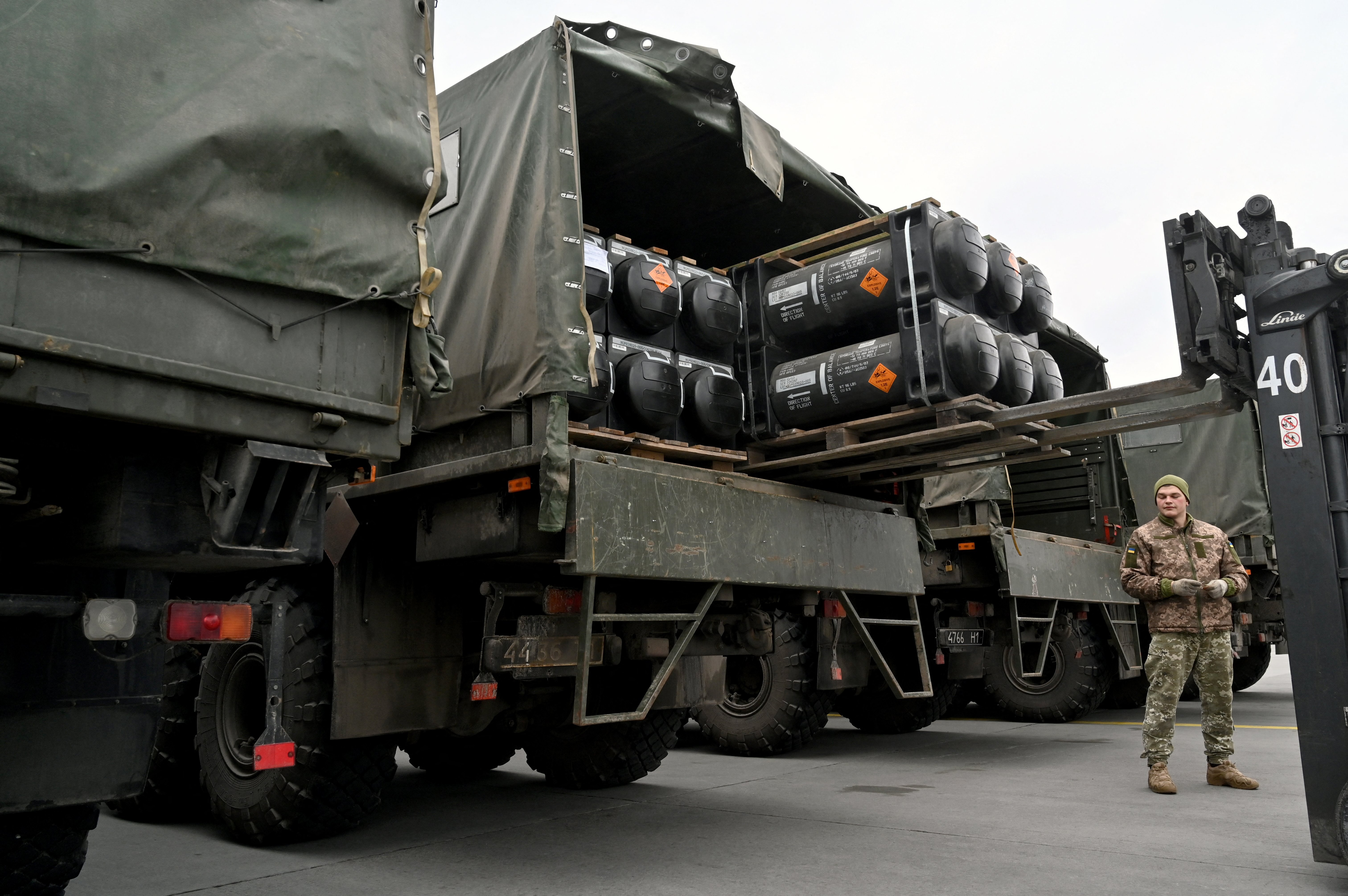 Ukrainian servicemen load a truck with the FGM-148 Javelin American man-portable anti-tank missile, provided by the US to Ukraine as part of a military support package, upon its delivery at Kyiv's Boryspil airport, Ukraine, on February 11.