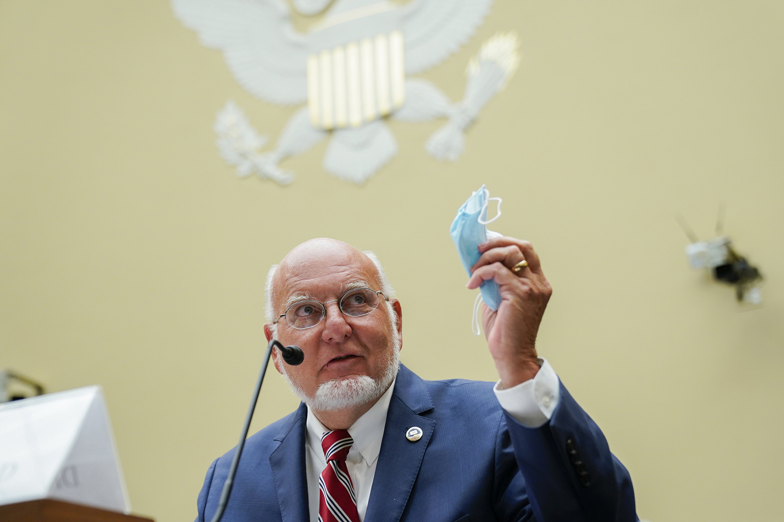 Robert Redfield, director of the Centers for Disease Control and Prevention (CDC) holds a protective mask while testifying during a House Select Subcommittee on the Coronavirus Crisis hearing on July 31 in Washington.