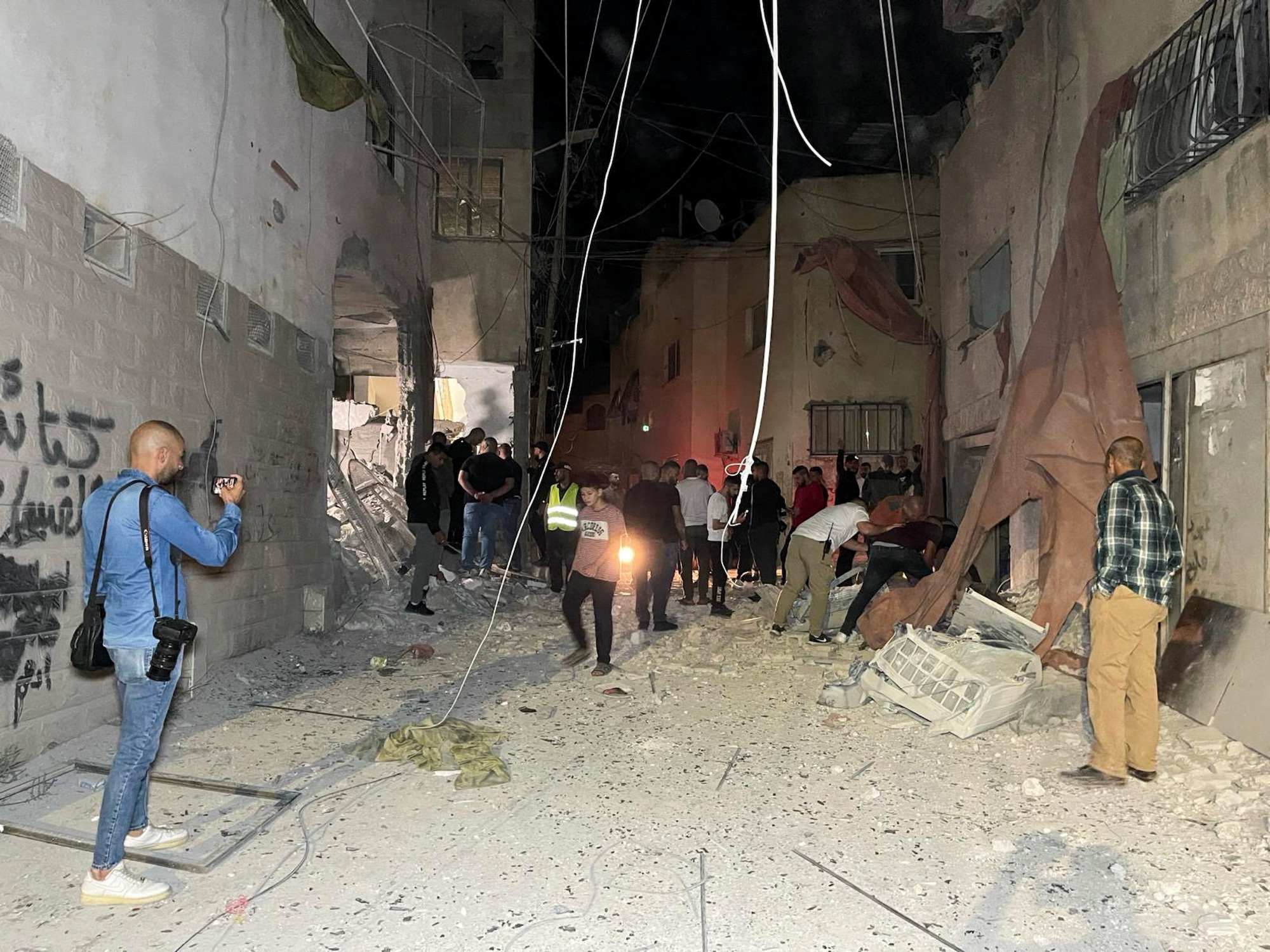 People inspect the damage after an Israeli airstrike hit a mosque in Jenin, West Bank, on Sunday.