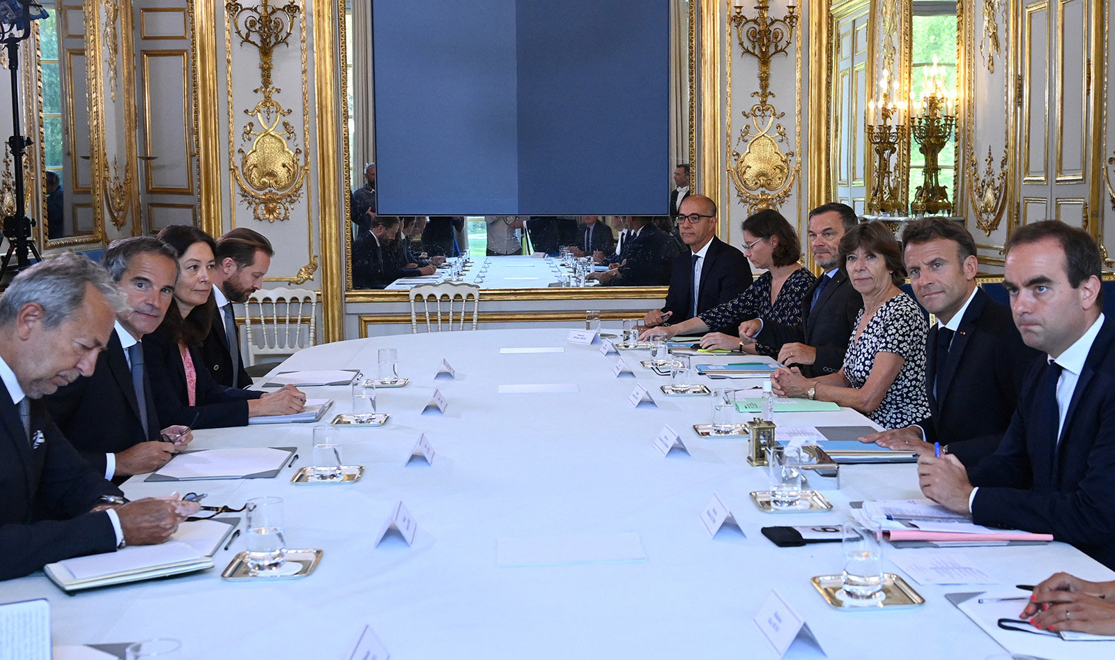 French President Emmanuel Macron, second right, attends a meeting with the Director General of the International Atomic Energy Agency (IAEA) Rafael Grossi, second left, at the Elysee Palace in Paris, France, on August 25.