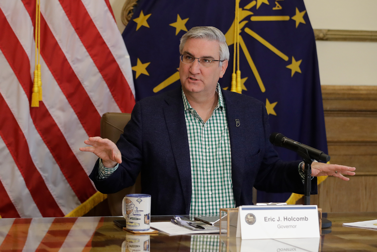 Indiana Gov. Eric Holcomb prepares to host a virtual media briefing on April 29, in Indianapolis.