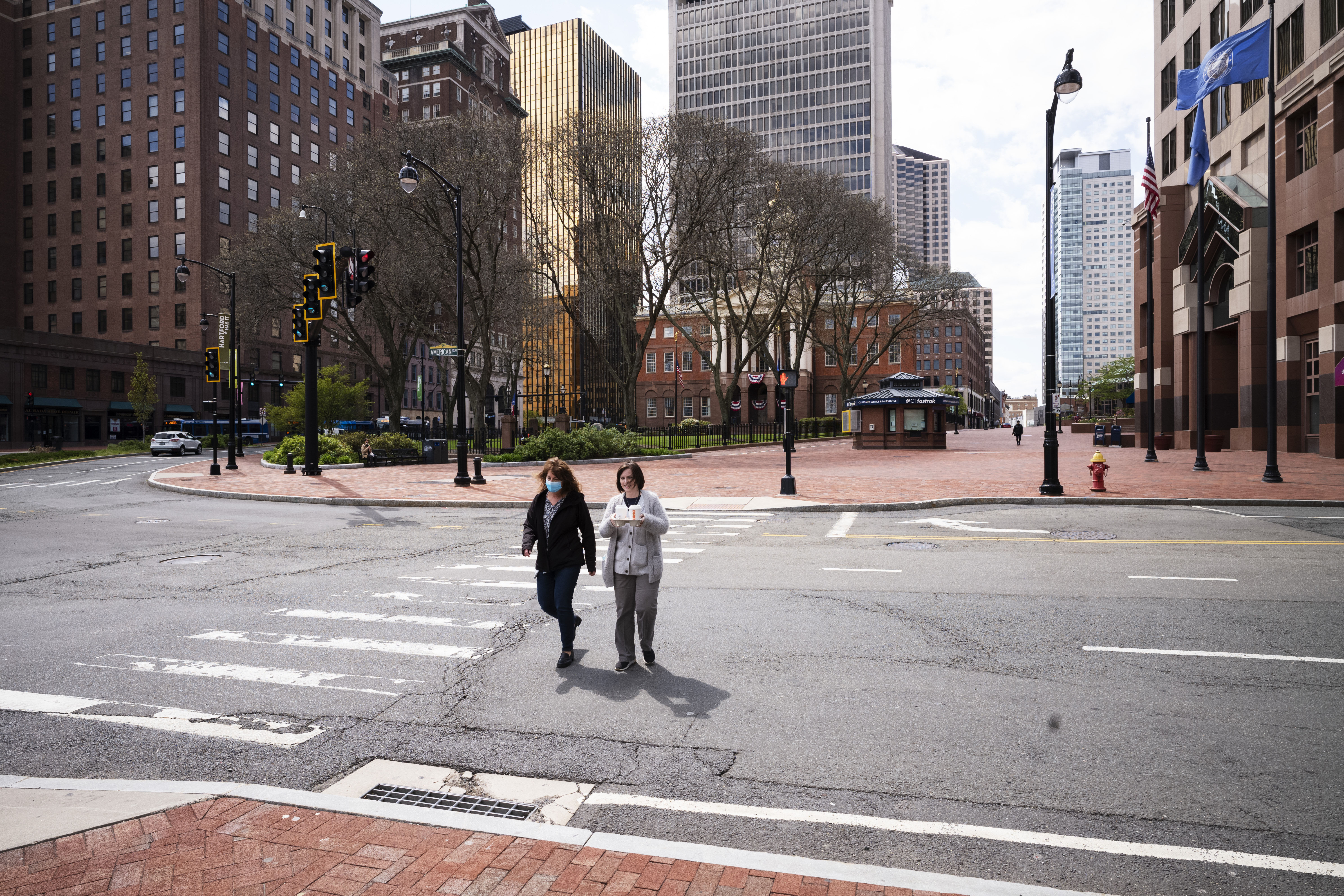 Women cross Market Street in downtown Hartford, Connecticut, on May 7.