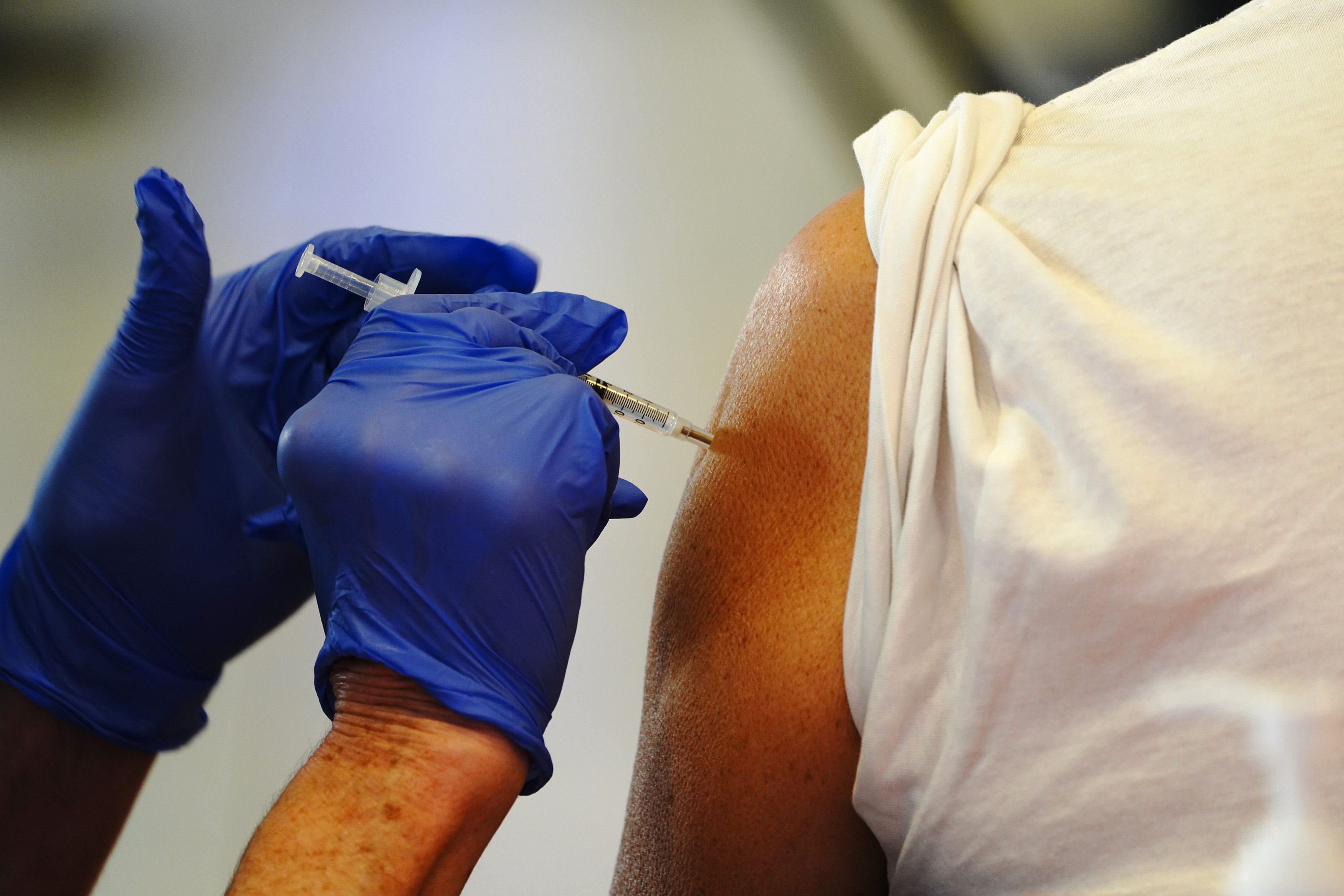 A health care worker administers a dose of the Pfizer-BioNTech Covid-19 vaccine at a mass vaccination site in Las Mesa, California, on February 11. 