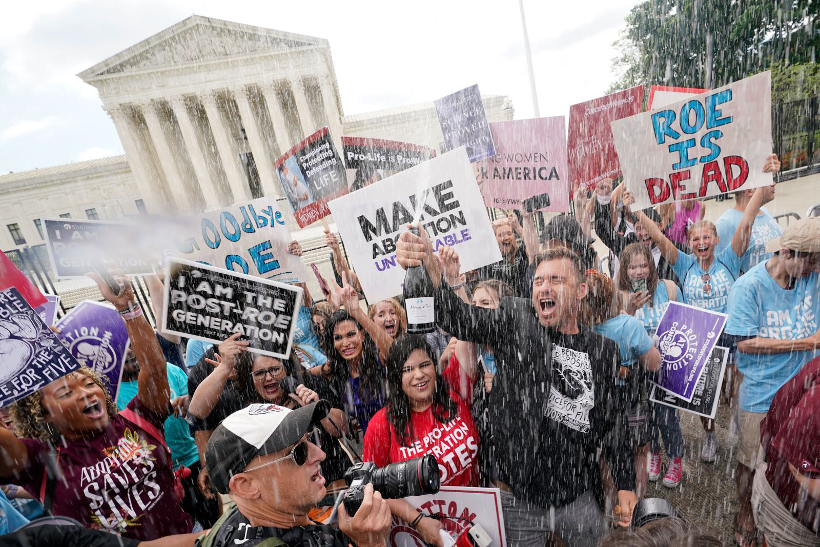 Anti-abortion demonstrators celebrate with champagne in front of the Supreme Court immediately following the decision to overturn Roe vs Wade.