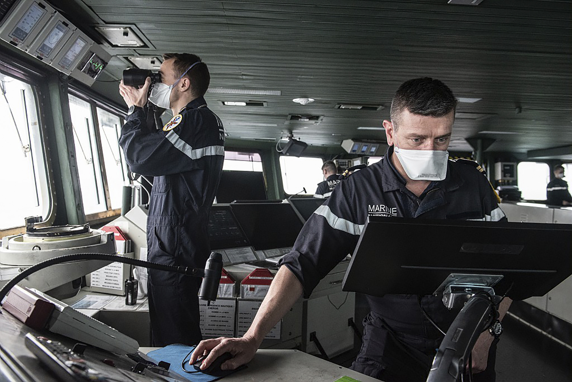 This photo provided on April 10 by the French Navy (Marine Nationale) shows sailors aboard the French aircraft carrier Charles de Gaulle in the Atlantic Ocean on April 8.
