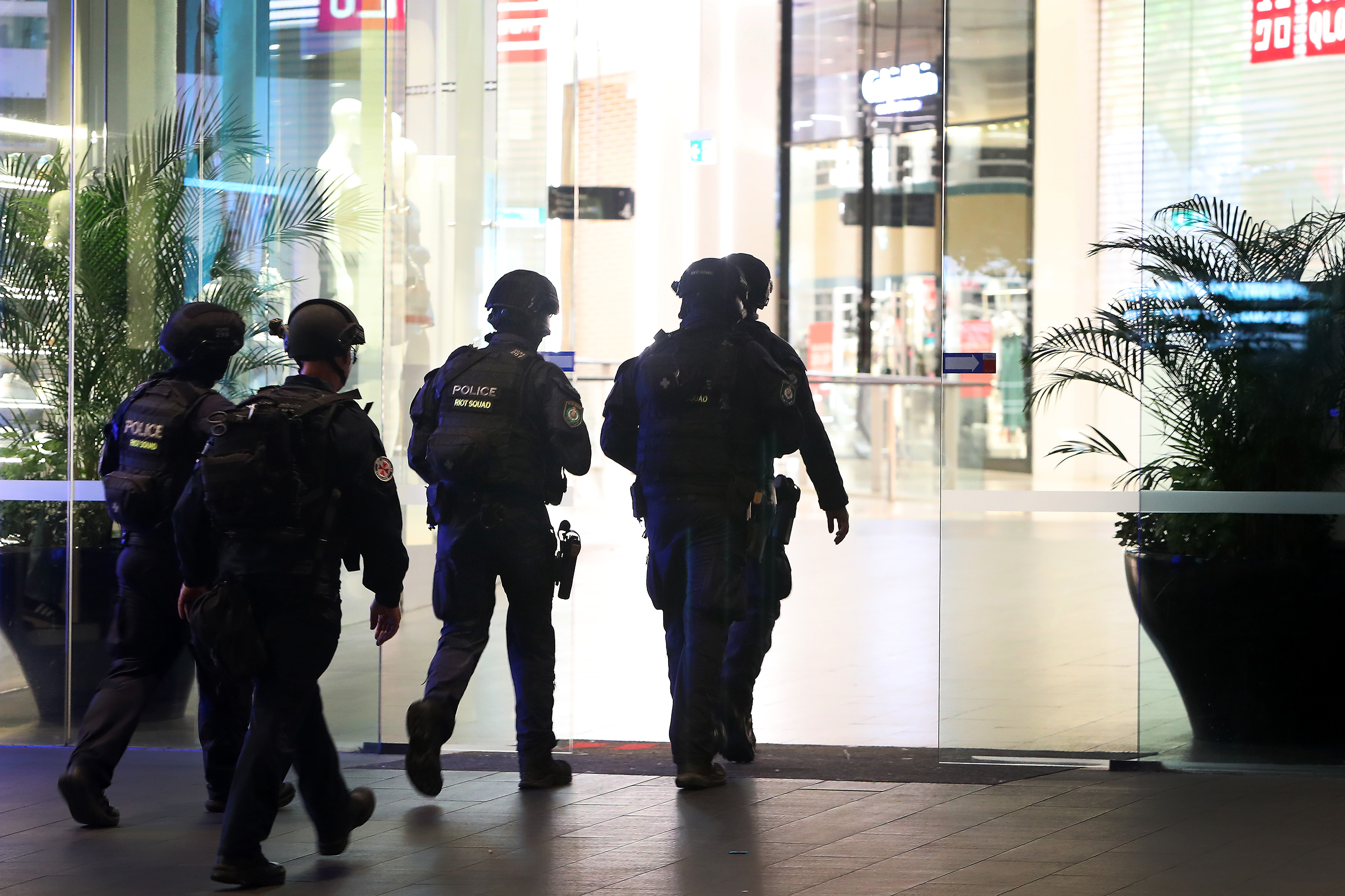 Police enter the shopping mall. 