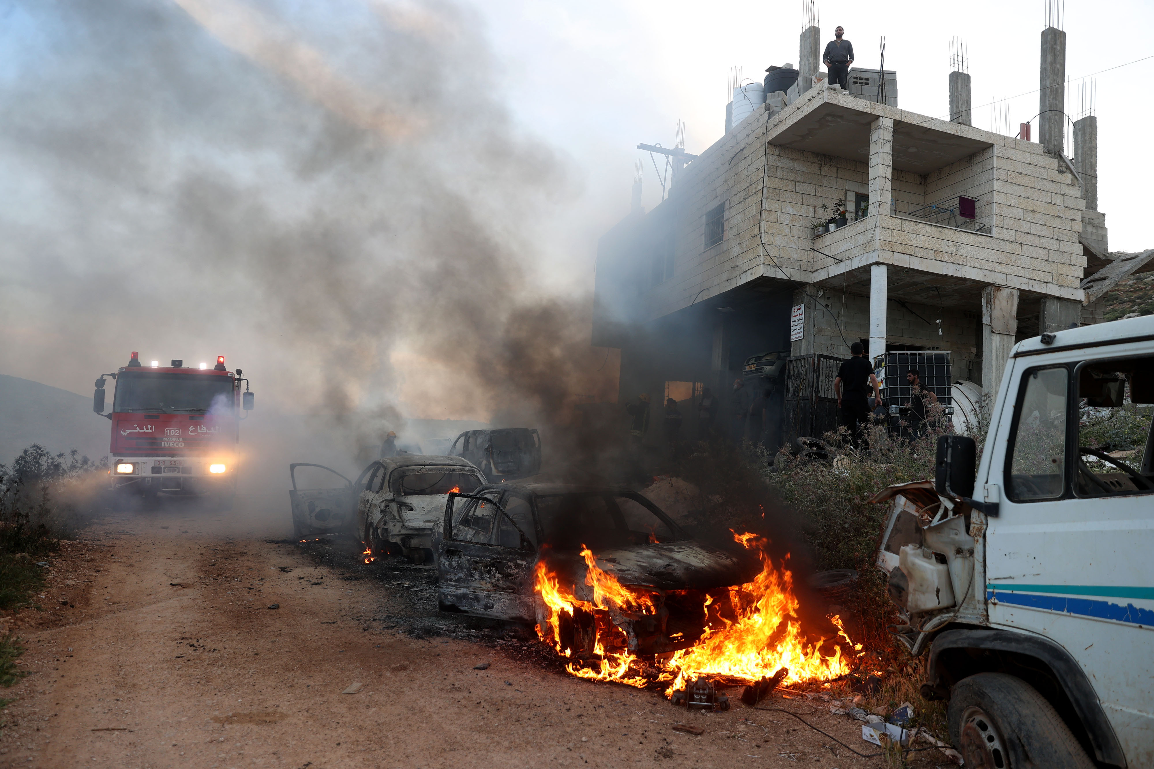 A view of damaged houses and burning vehicles after a raid by Israeli settlers on a town near Ramallah, West Bank on April 12.