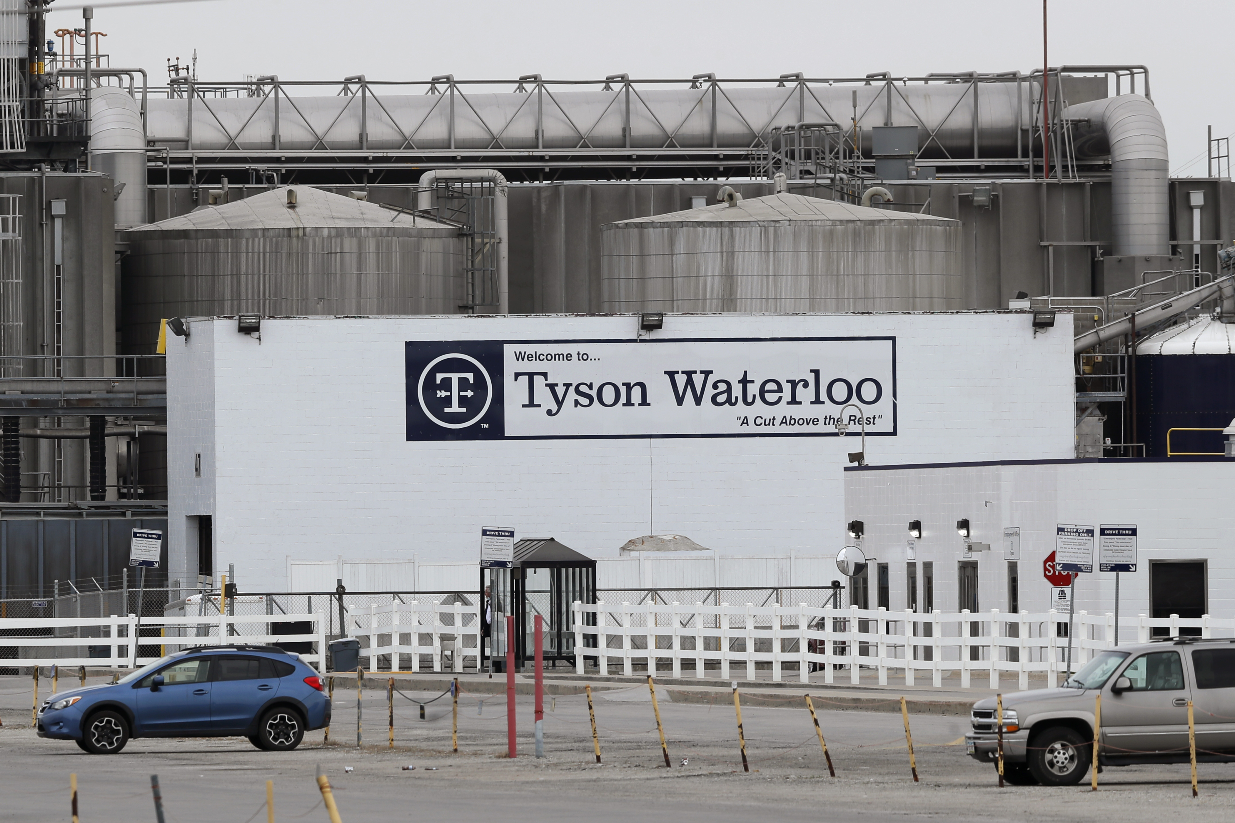 Vehicles sit in a near-empty parking lot outside a Tyson Foods plant in Waterloo, Iowa, on May 1.