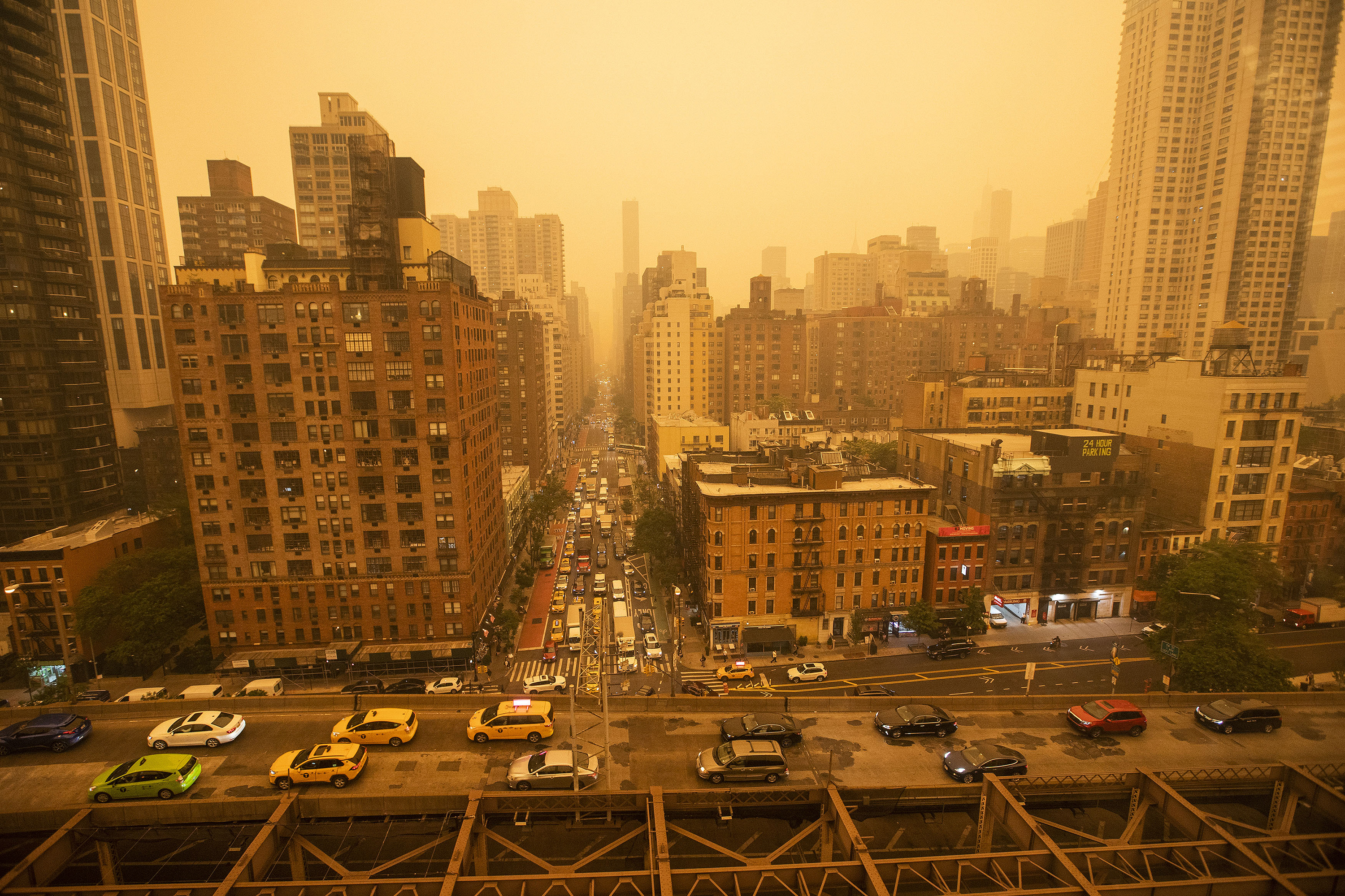 Traffic moves over the Ed Koch Queensboro Bridge as smoke from Canadian wildfires casts a haze over the area on June 7, in New York City.