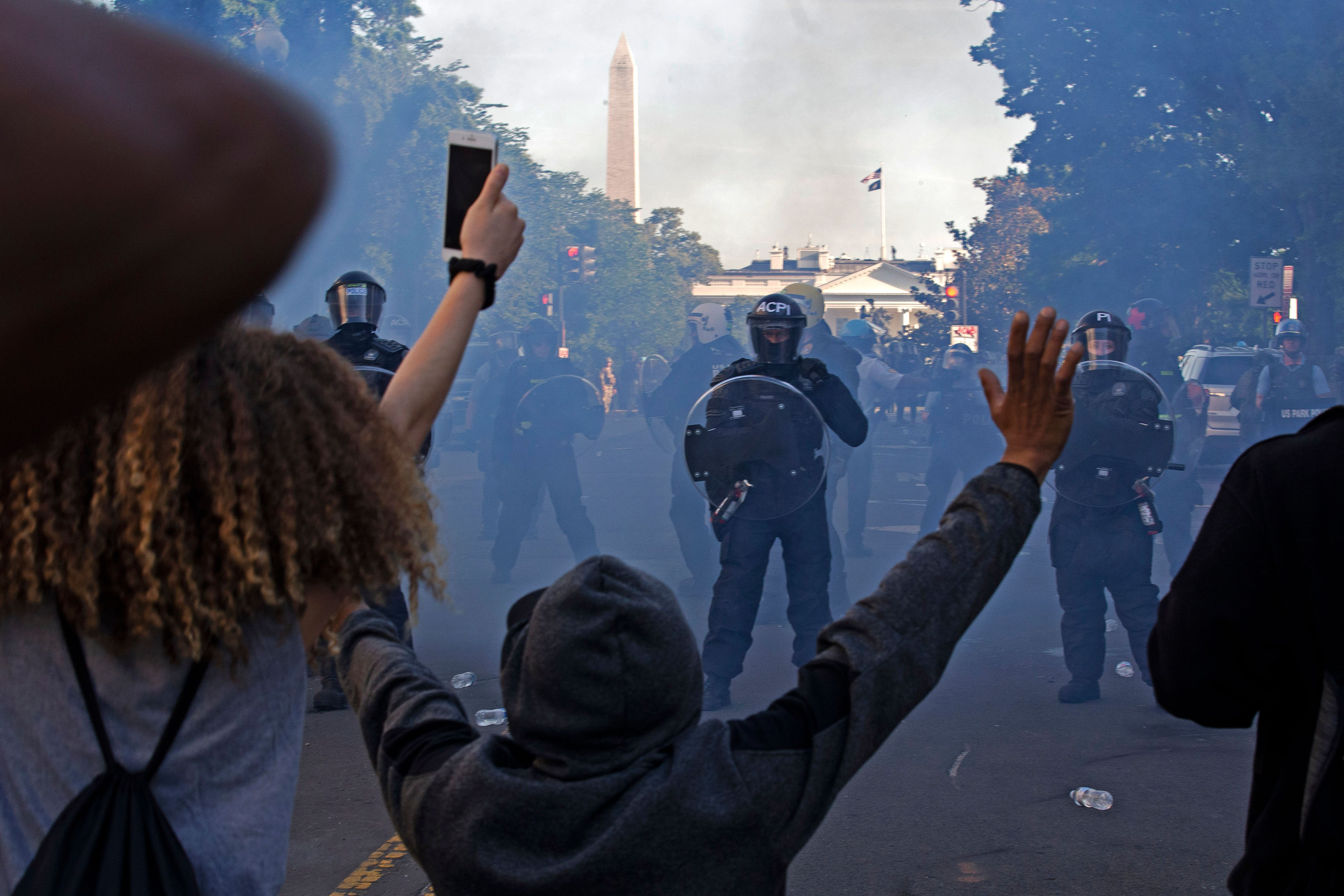 Police officers wearing riot gear push back demonstrators near the White House in Washington on June 1.