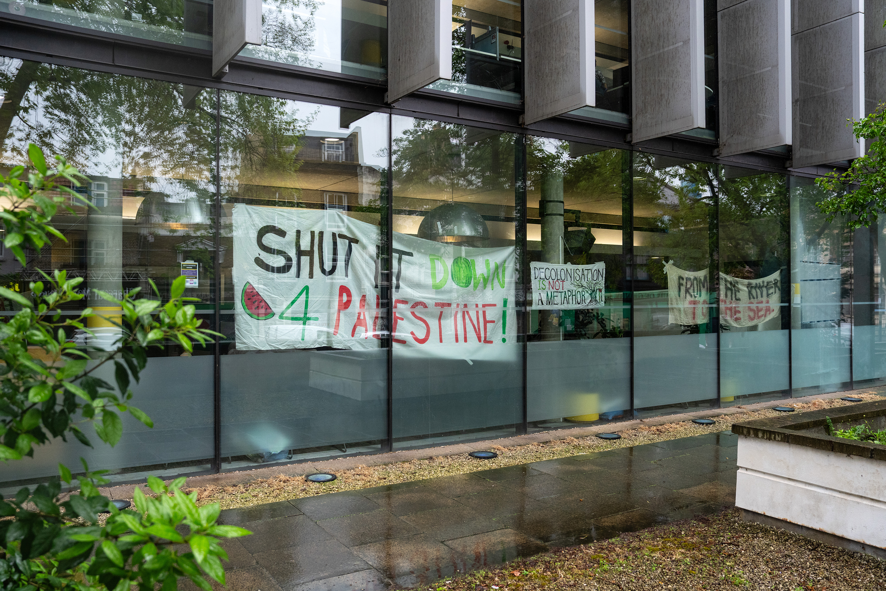 Banners in support of Palestinians are displayed in the window of Goldsmiths university library in London on May 3.