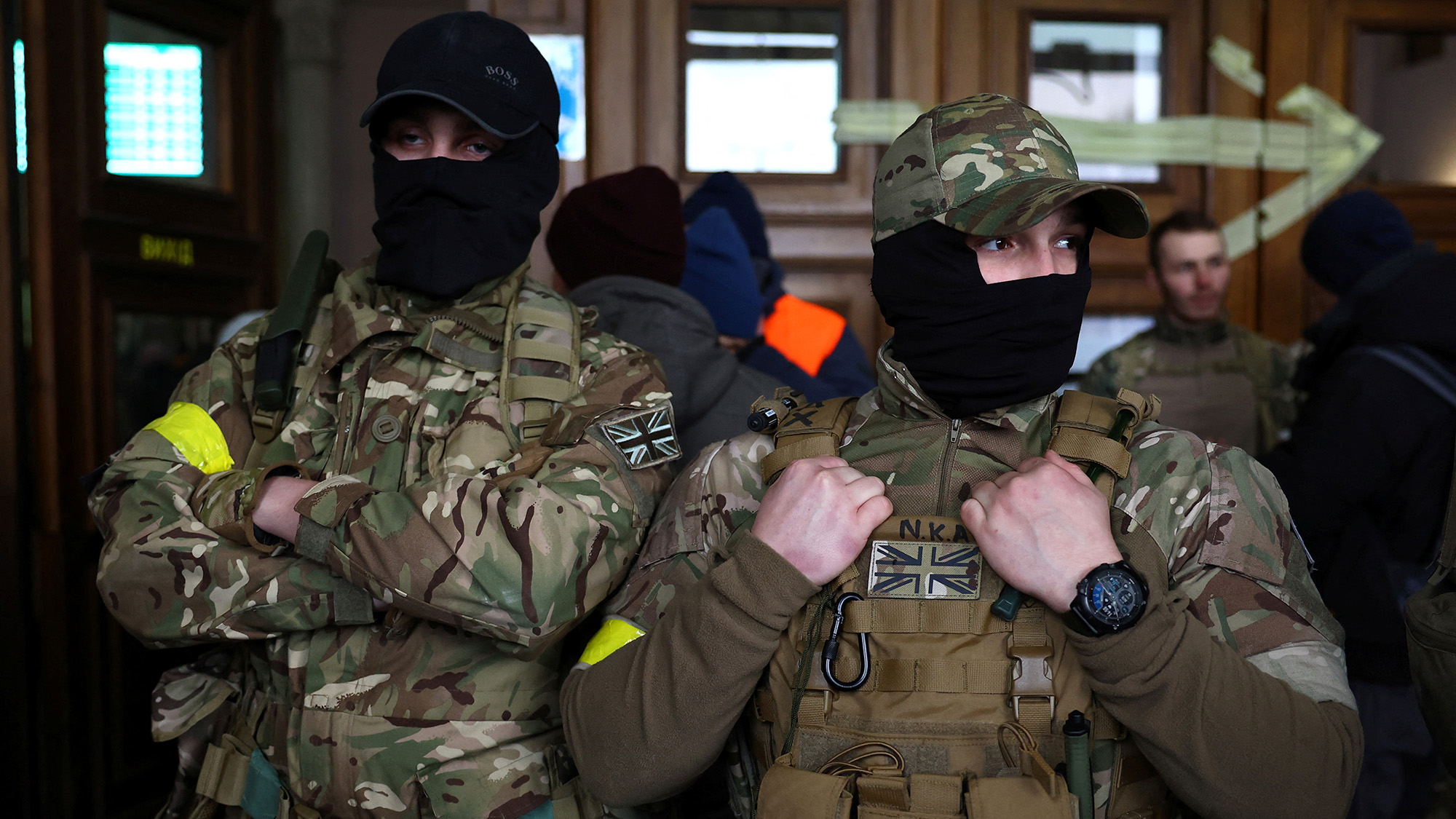 Two foreign fighters from the UK are seen as they prepare to depart to the front line at the main train station in Lviv, Ukraine on March 5.