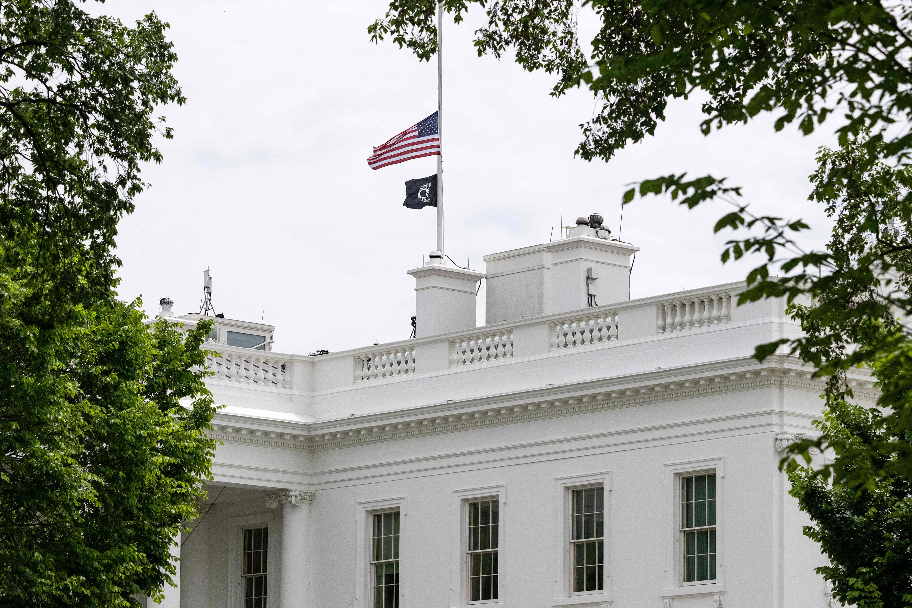 The US flag flies at half-staff over the White House in Washington, DC, on May 7. 